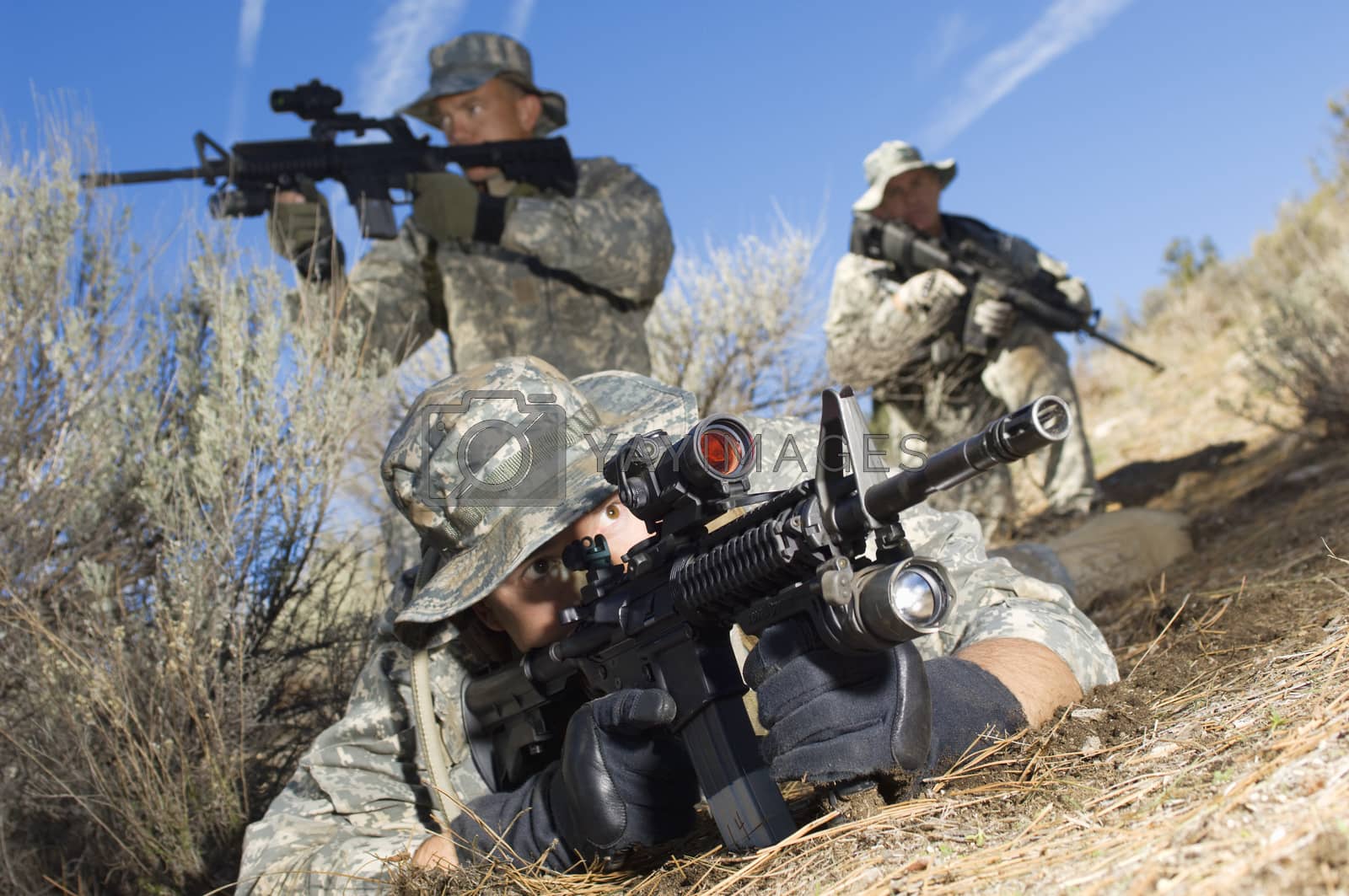 Royalty free image of Soldiers armed with machine guns and ready to shoot by moodboard