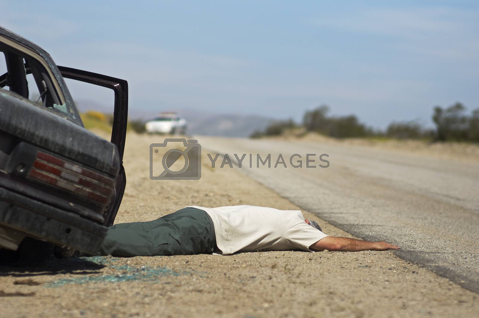 Royalty free image of Victim of car accident lying on roadside by moodboard
