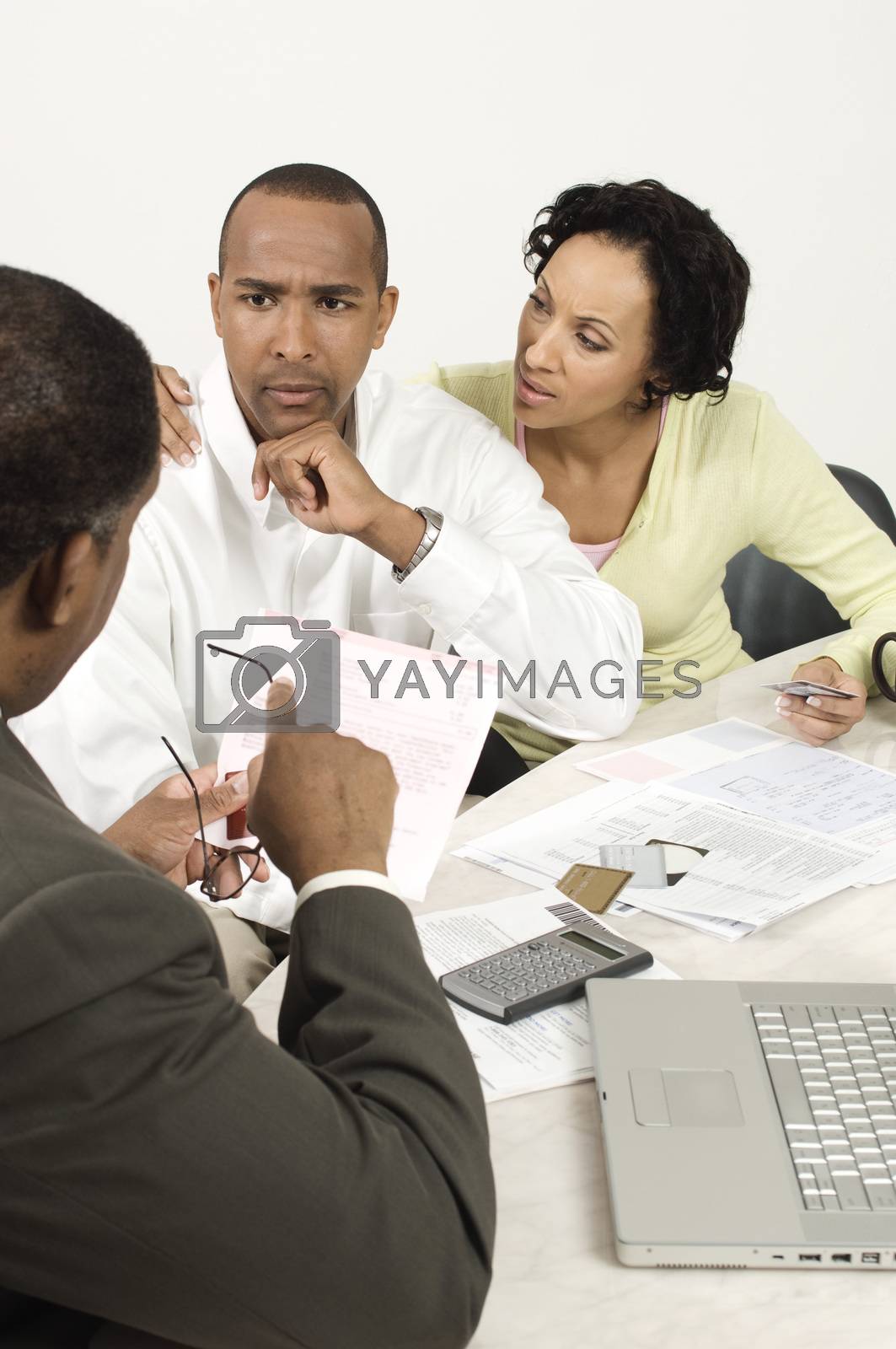 Royalty free image of An African American couple having discussion over an issue with financial advisor by moodboard
