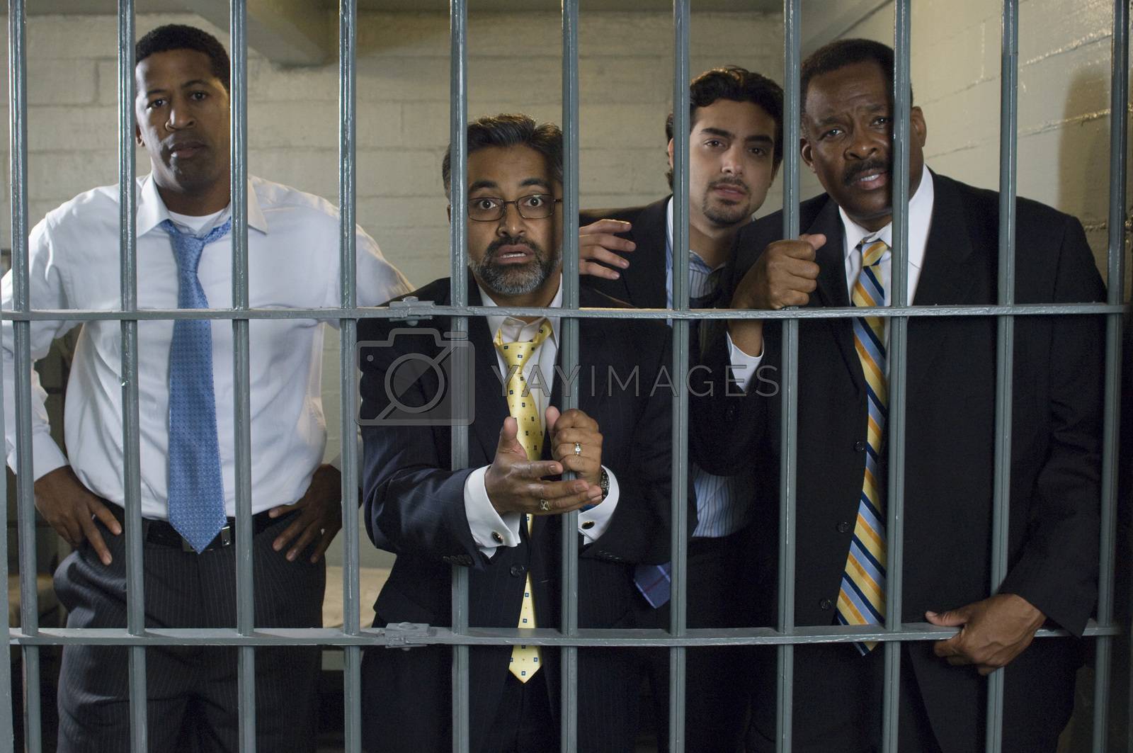 Royalty free image of Four people in prison cell by moodboard