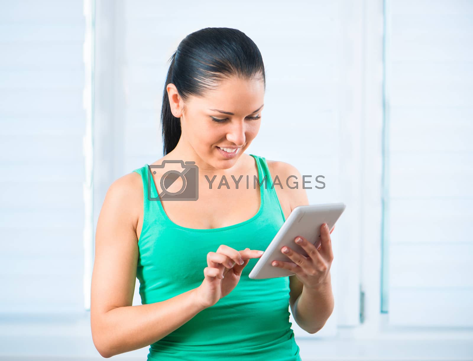 Royalty free image of girl with the TouchPad by GekaSkr
