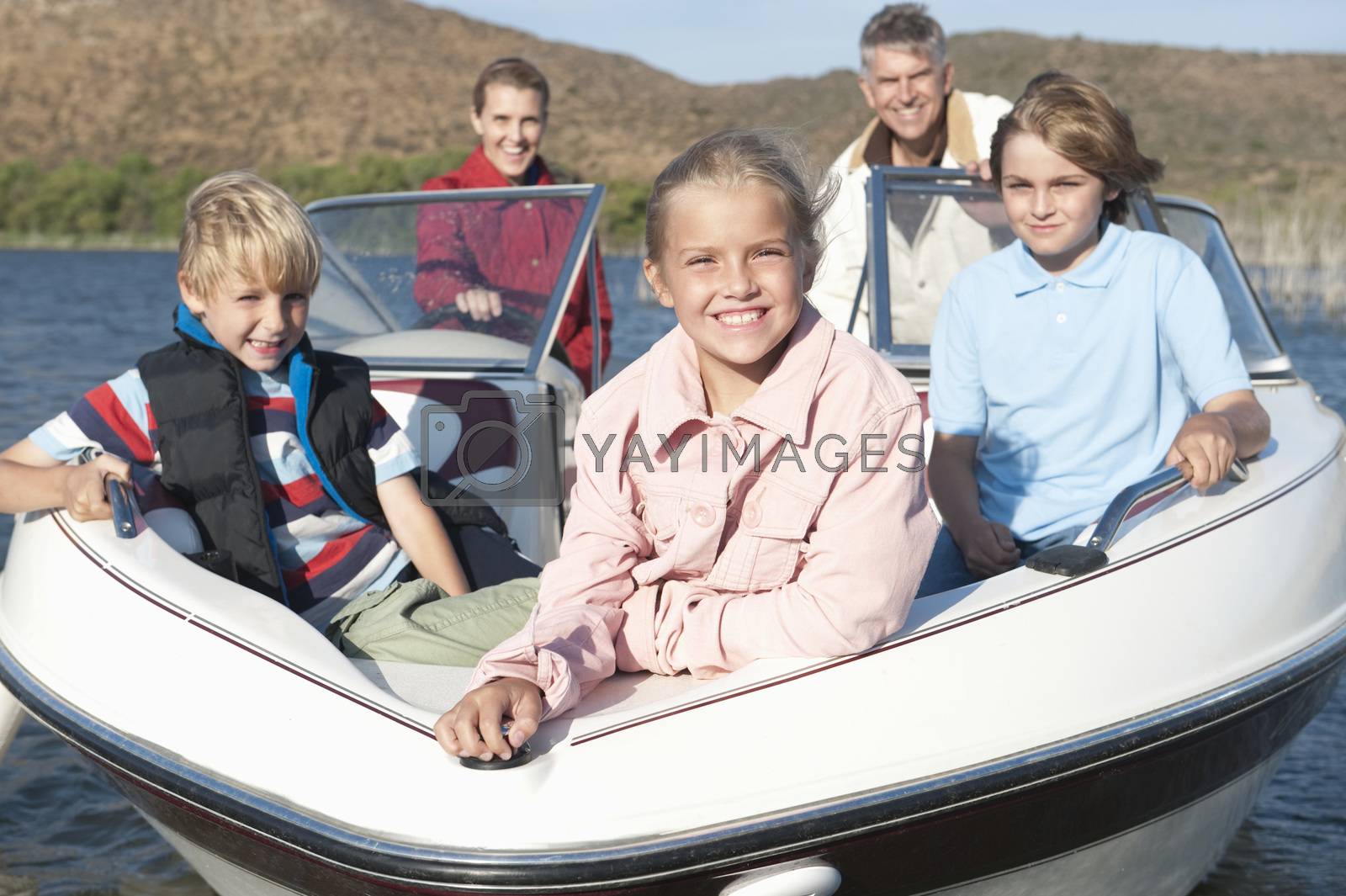 Royalty free image of Family of five in speedboat on lake by moodboard