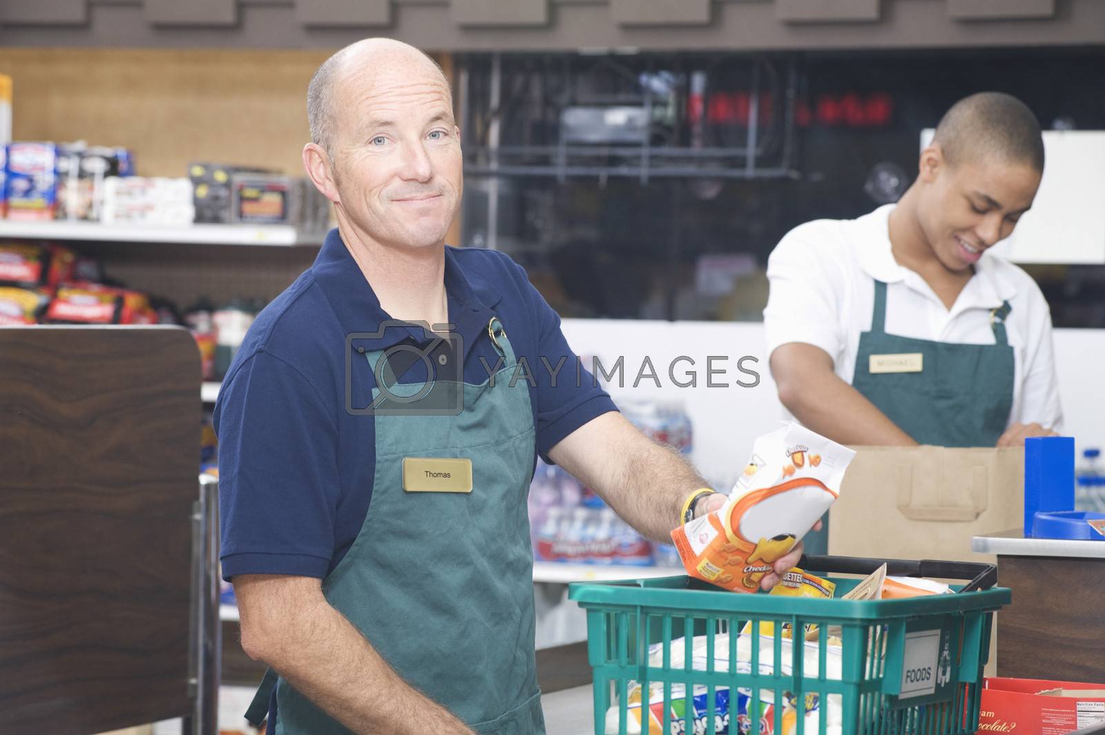 Royalty free image of Supermarket employee and check out assistant by moodboard