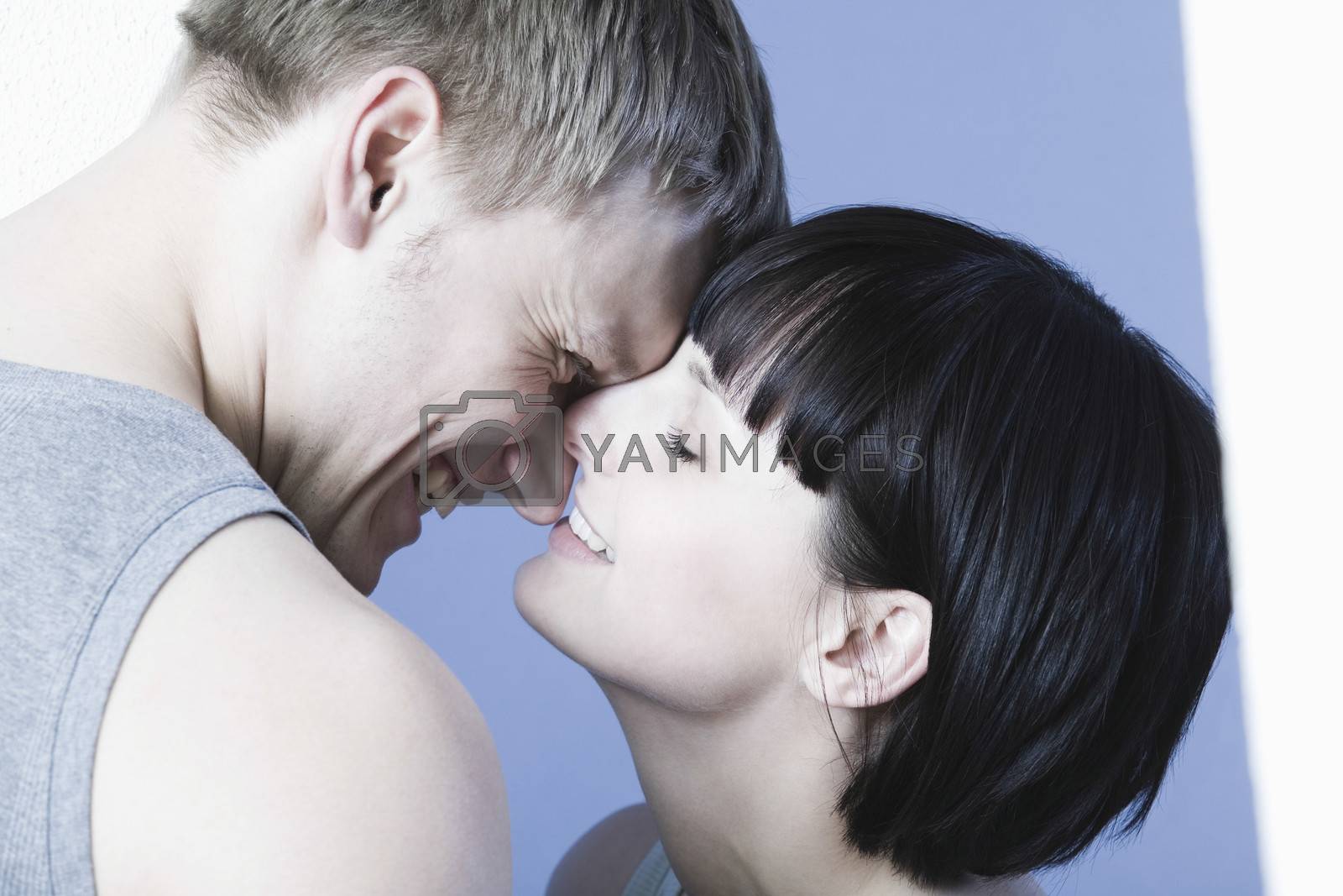Royalty free image of Young couple kissing by moodboard