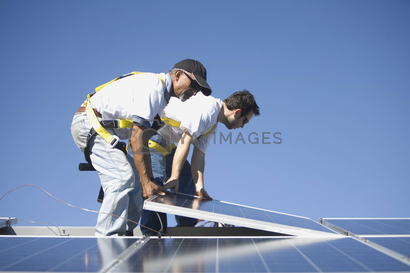 Royalty free image of Two men lifting a solar panel by moodboard