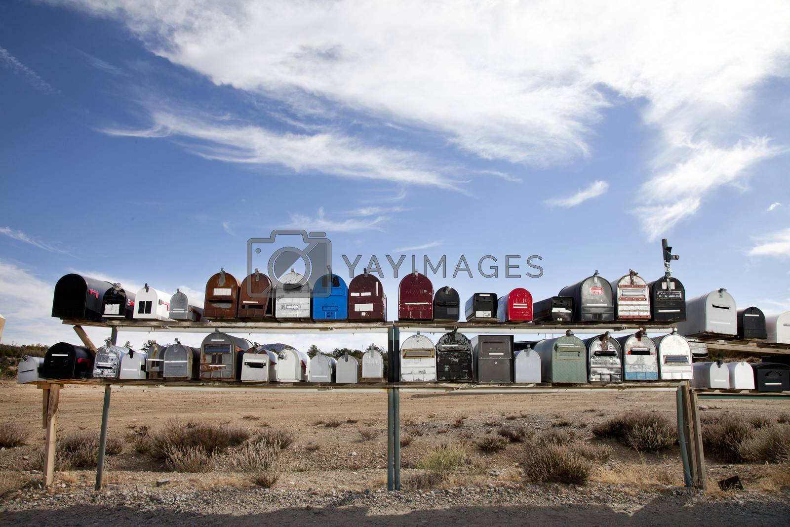 Royalty free image of Front view of rows of mailboxes in desert by moodboard