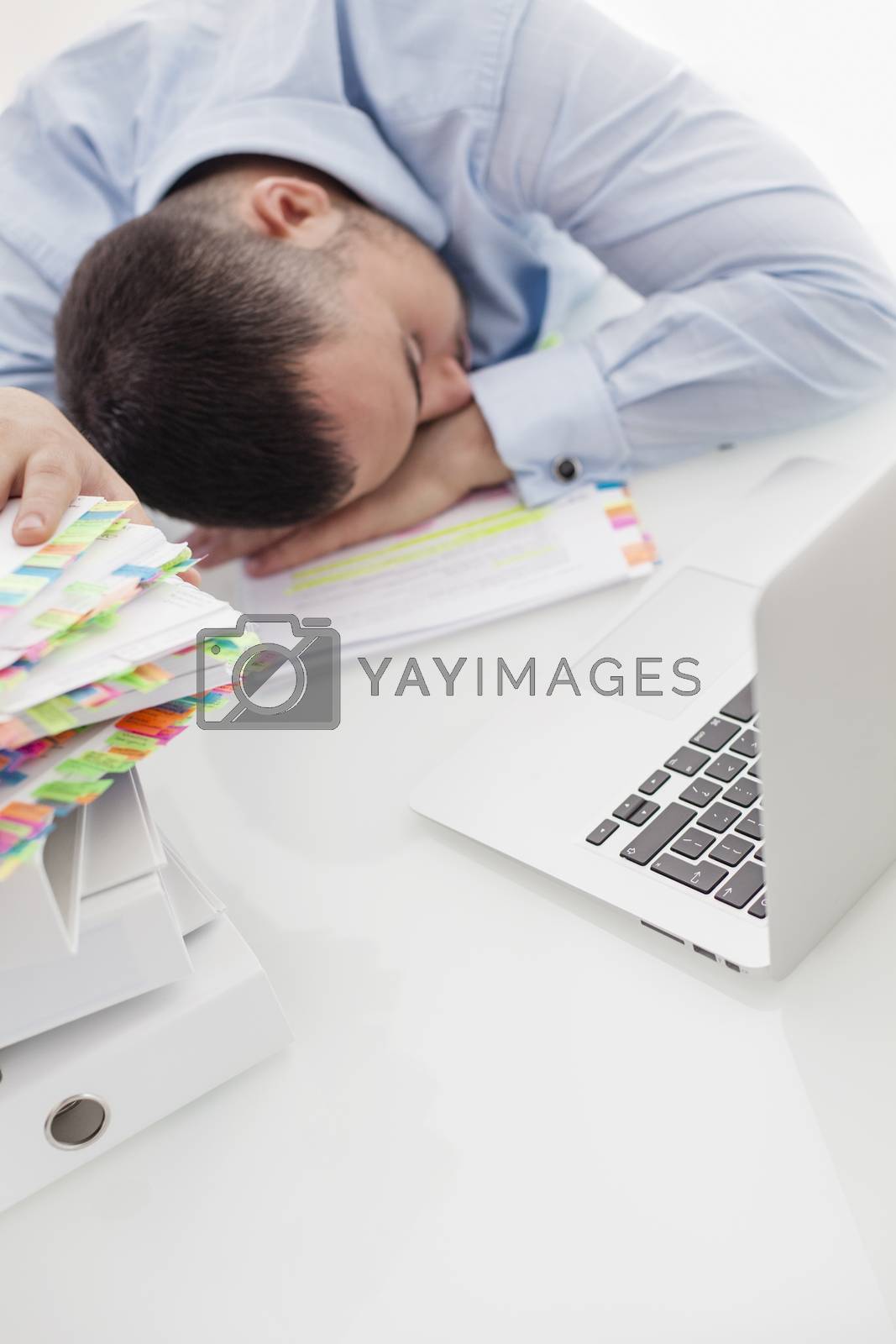 Royalty free image of Close-up view of Caucasian businessman asleep at his desk by moodboard