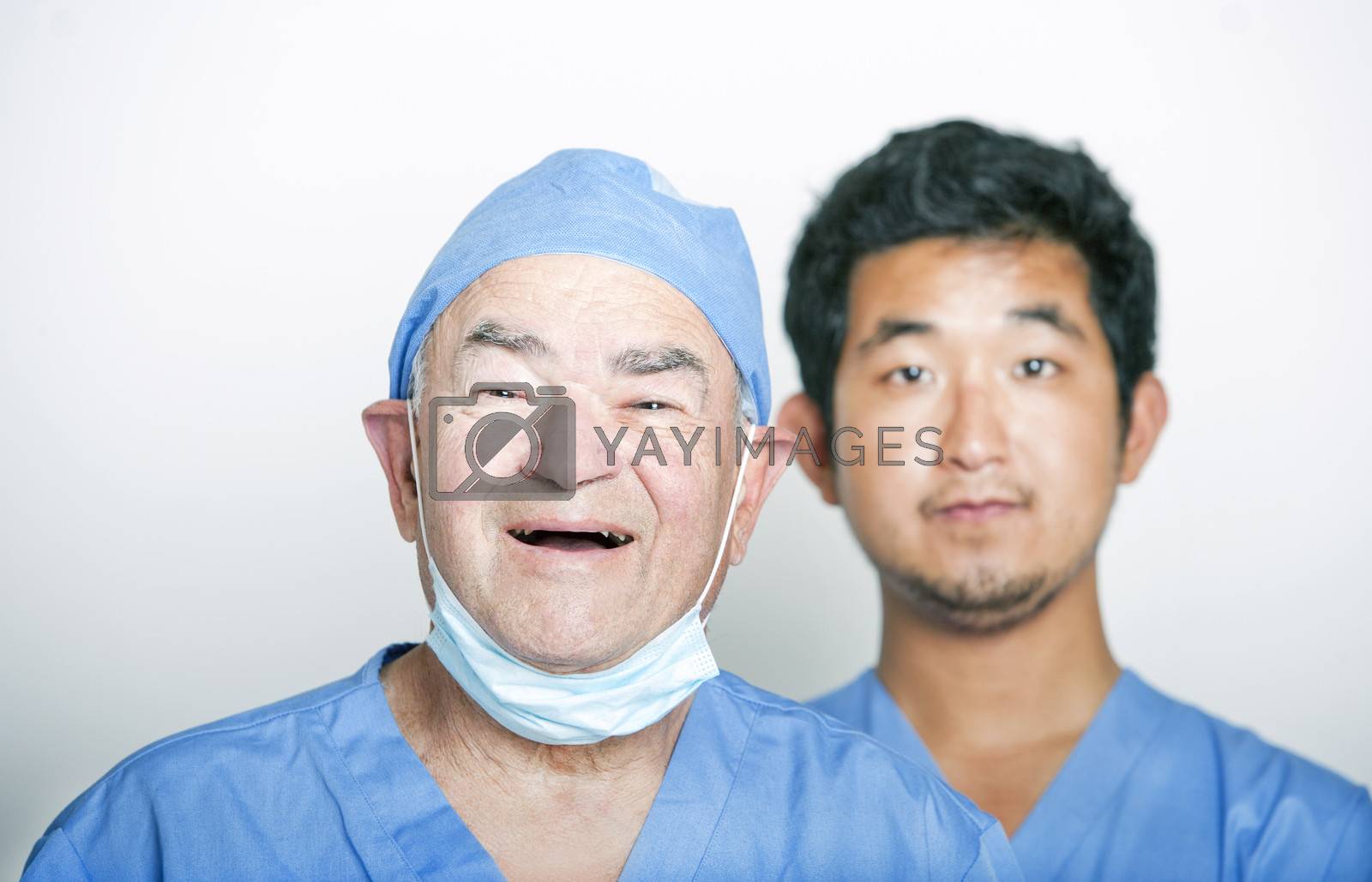 Royalty free image of A portrait of Senior adult surgeon and a young Asian doctor by moodboard