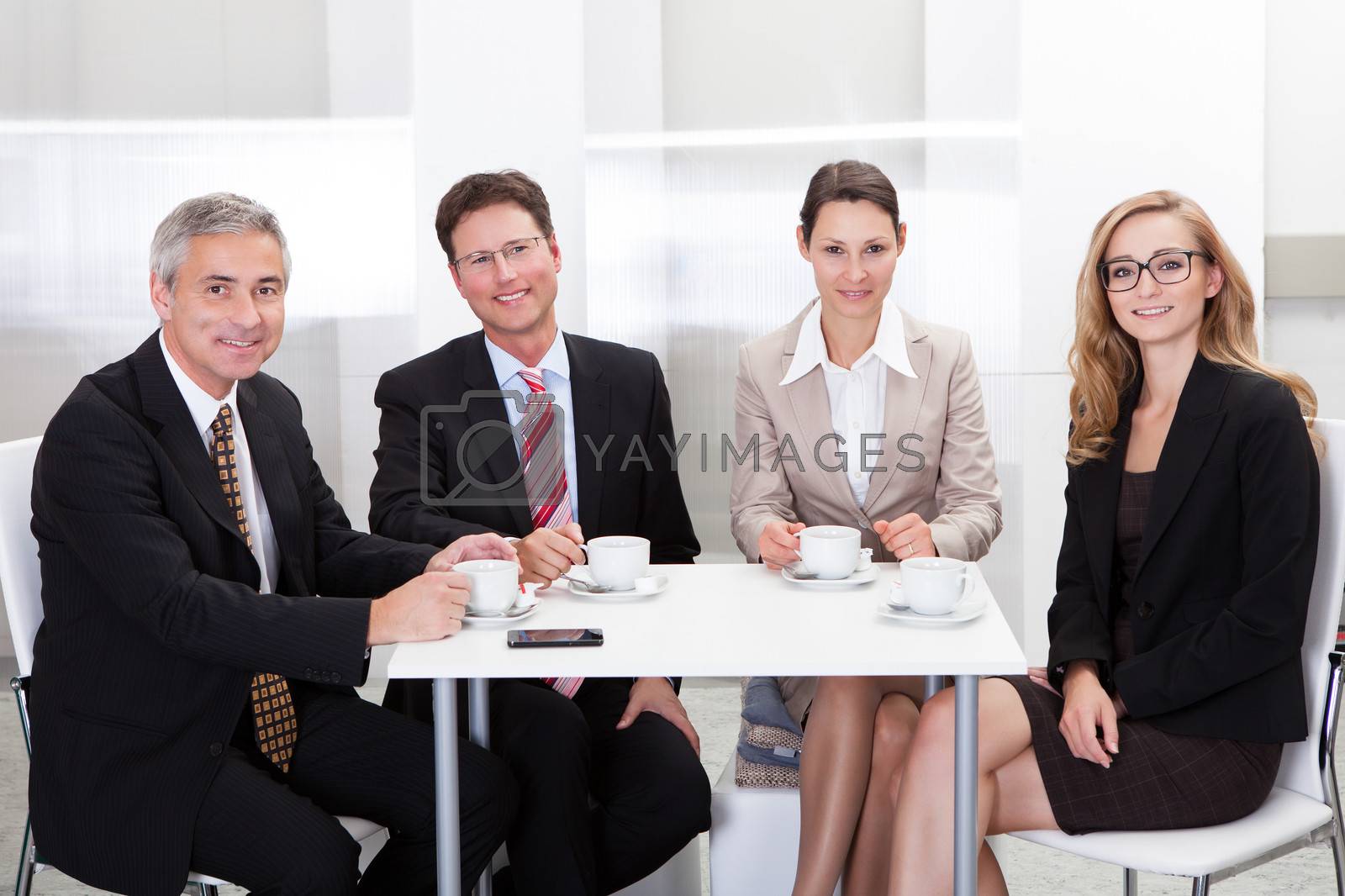 Royalty free image of Business executives enjoying coffee by AndreyPopov