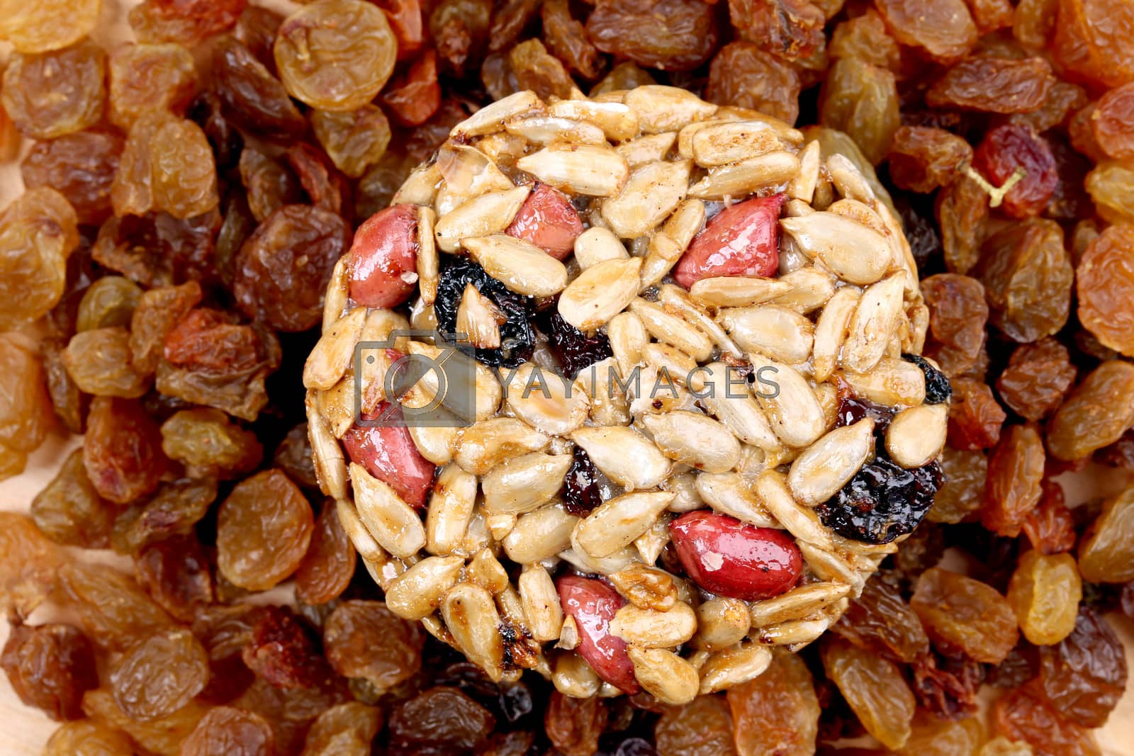 Royalty free image of Round candied seeds and nuts with raisins. by indigolotos