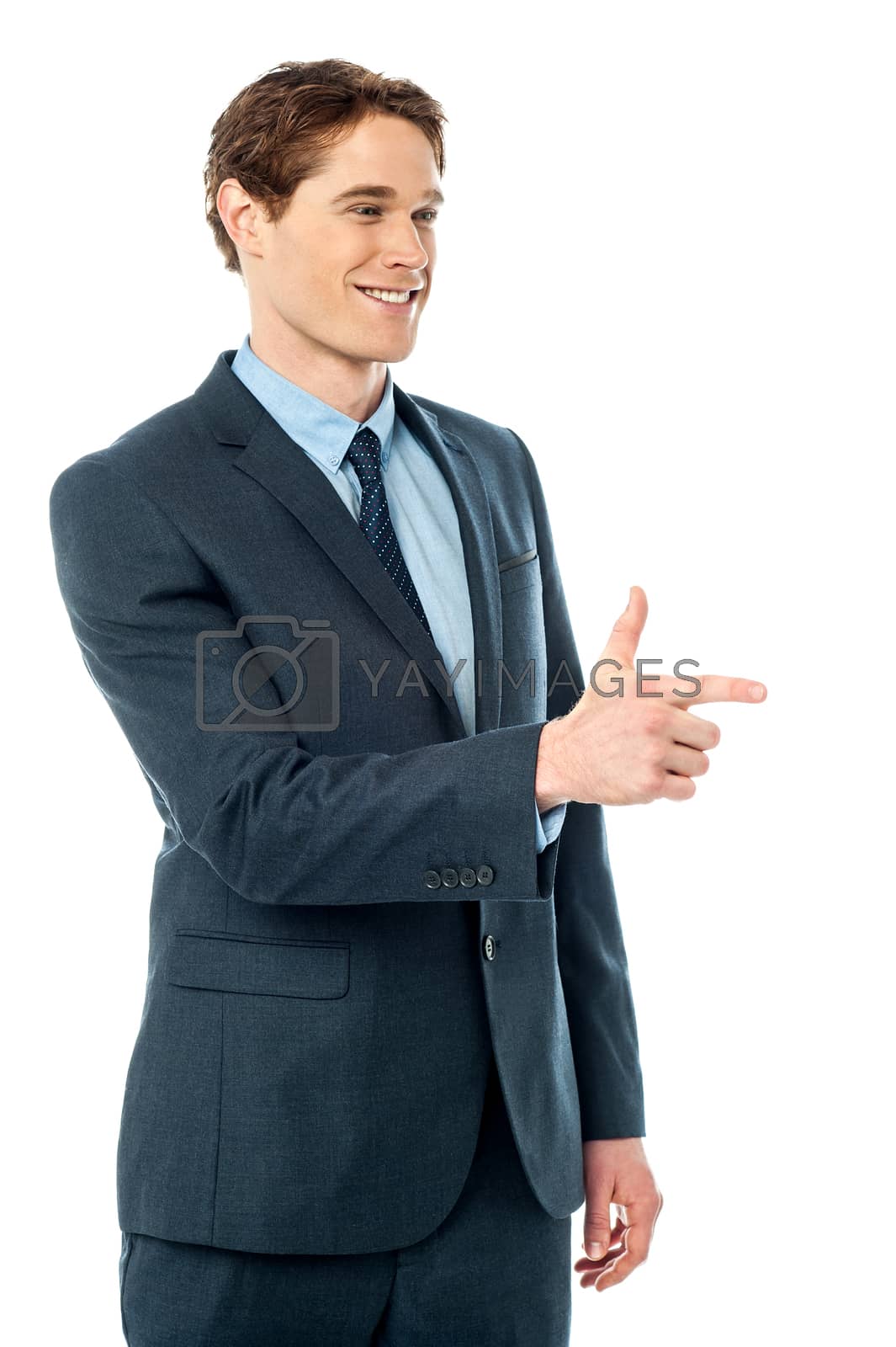 Royalty free image of Cheerful businessman pointing away by stockyimages