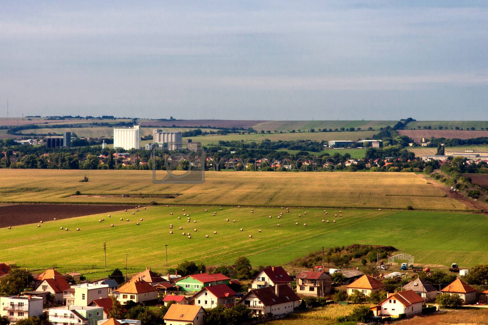 In the countryside landscape with houses and fields in autumn