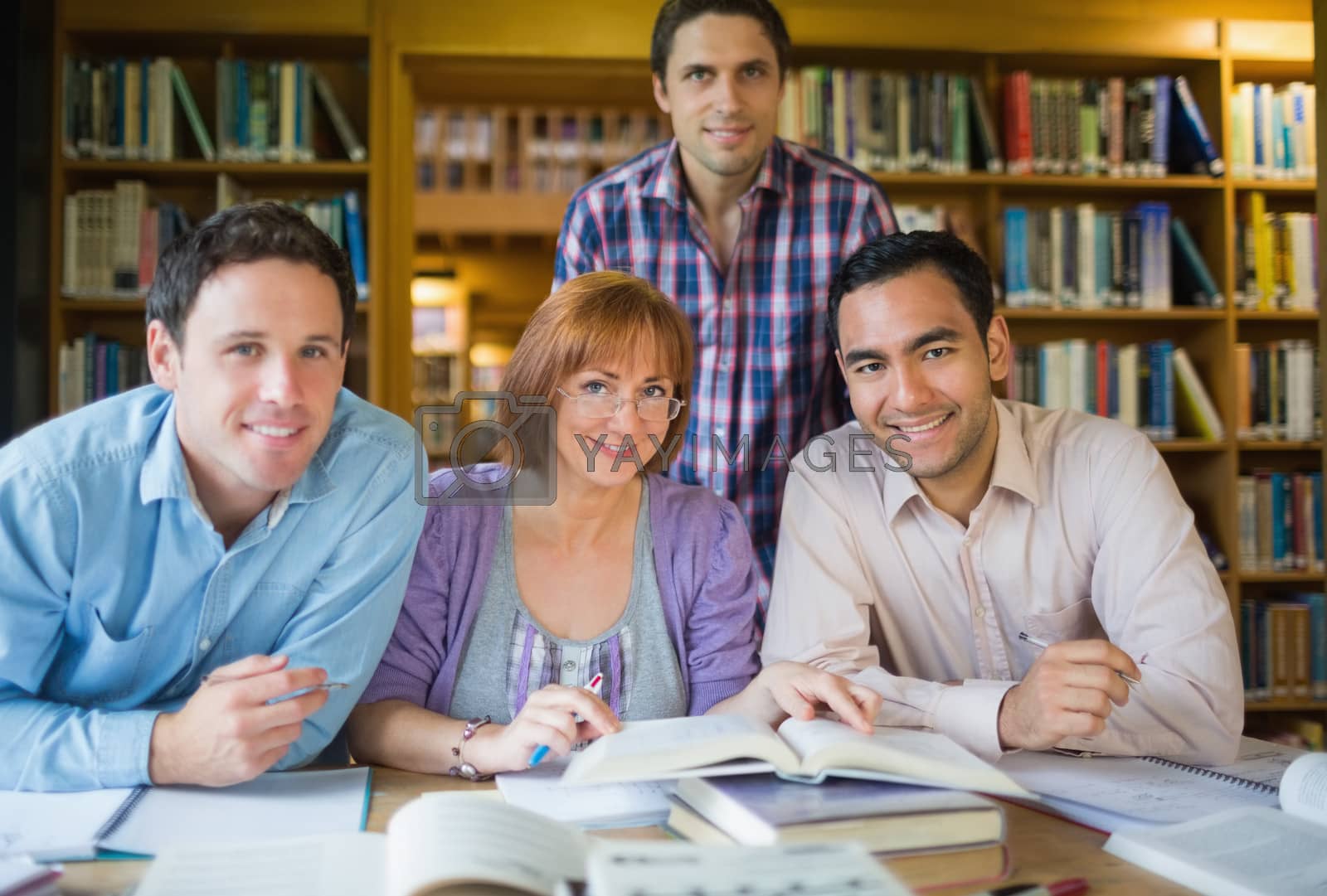 Royalty free image of Adult students studying together in the library by Wavebreakmedia
