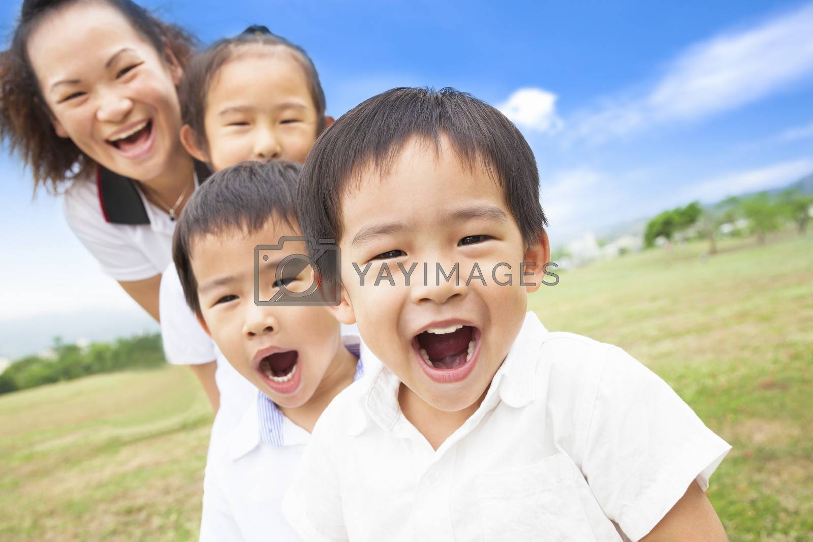 Royalty free image of Asian smiling family playing on meadow and sunny day by tomwang