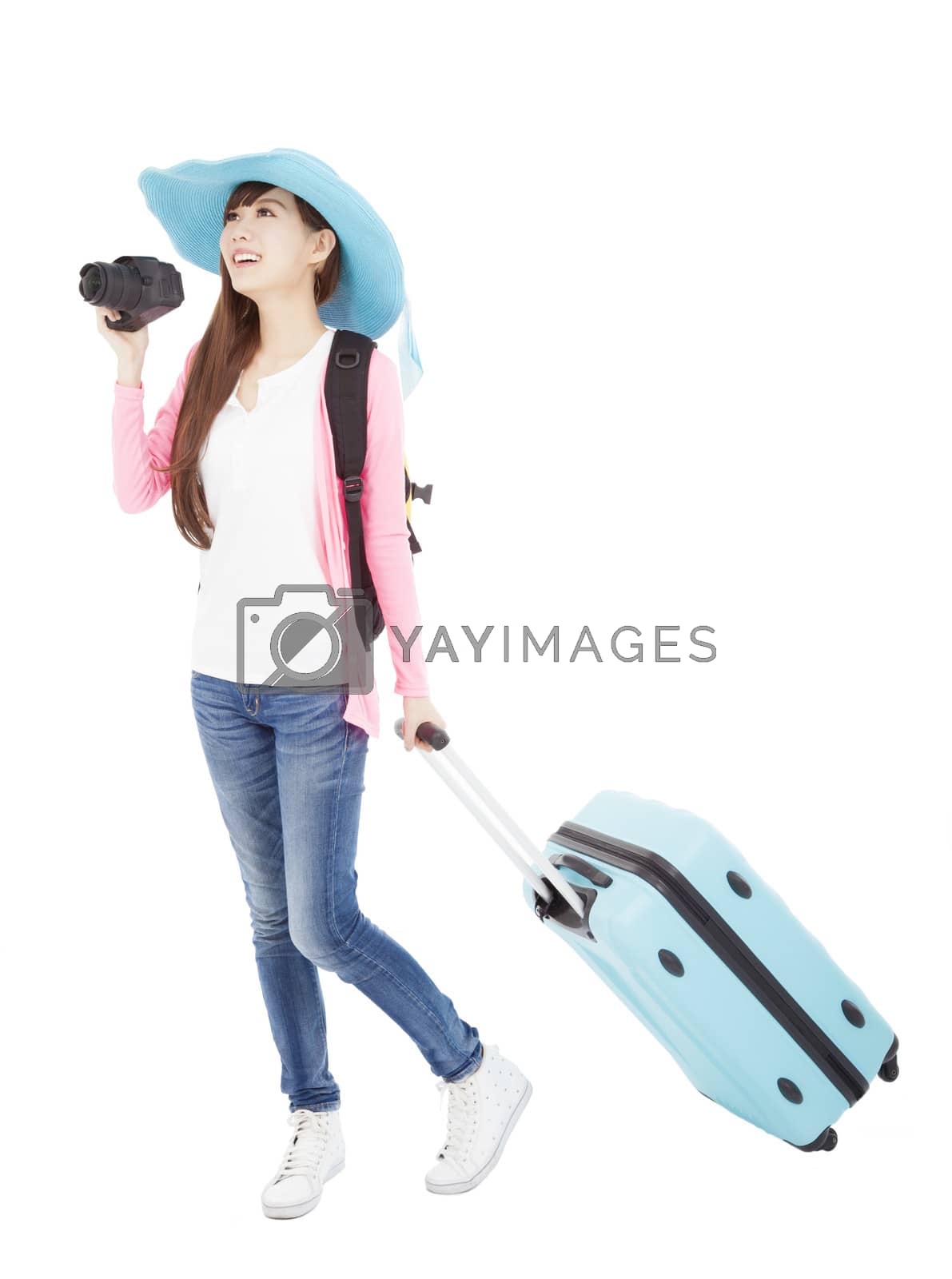Royalty free image of young woman holding traveling case and camera by tomwang