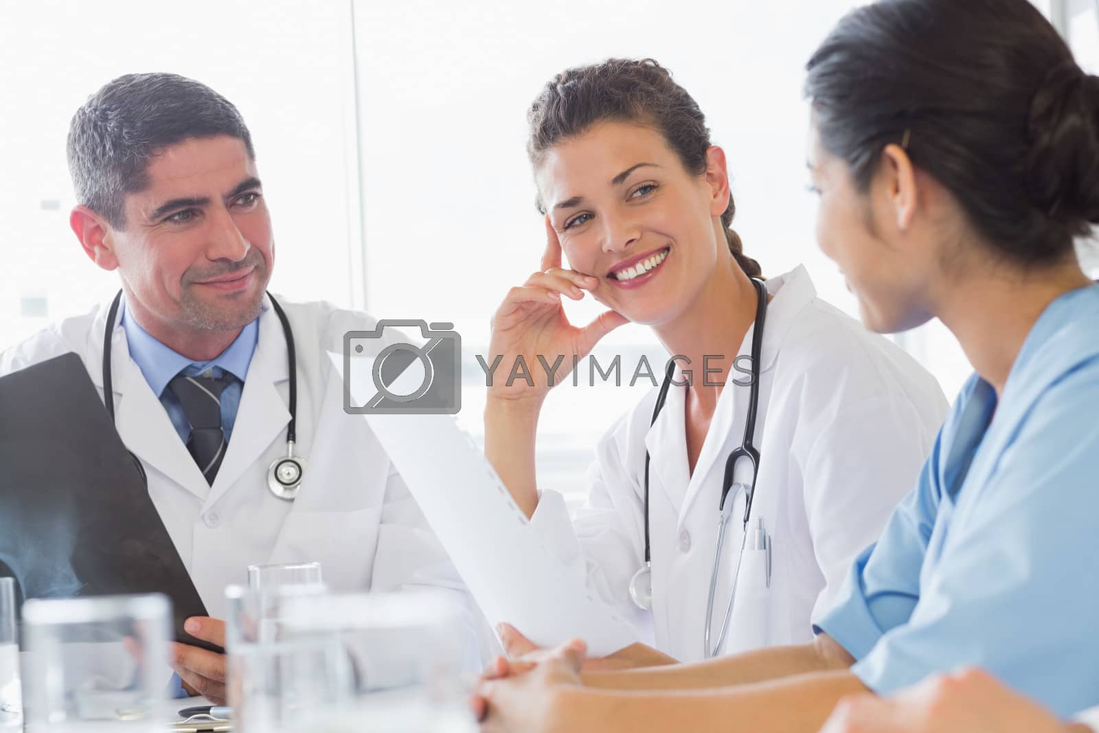 Royalty free image of Doctor discussing with nurse and colleague by Wavebreakmedia