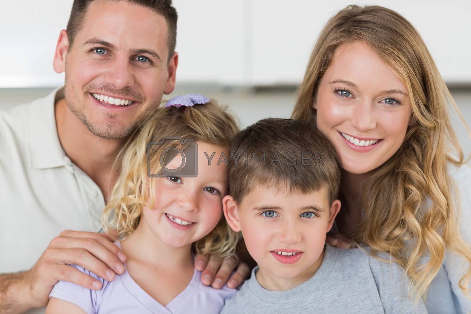 Closeup portrait of family smiling together in house