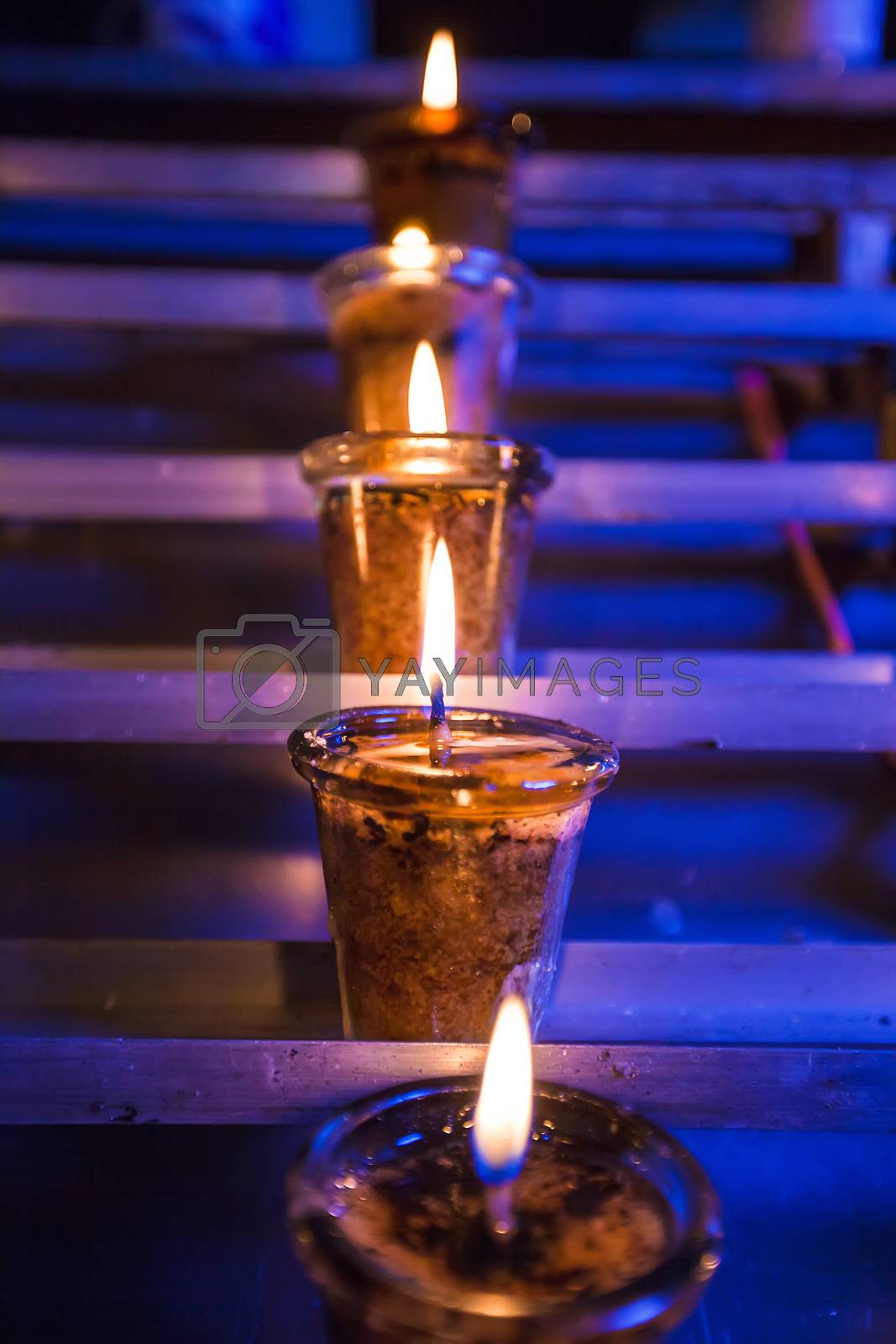 Royalty free image of Closeup of burning candles in the Catholic Church by travnikovstudio