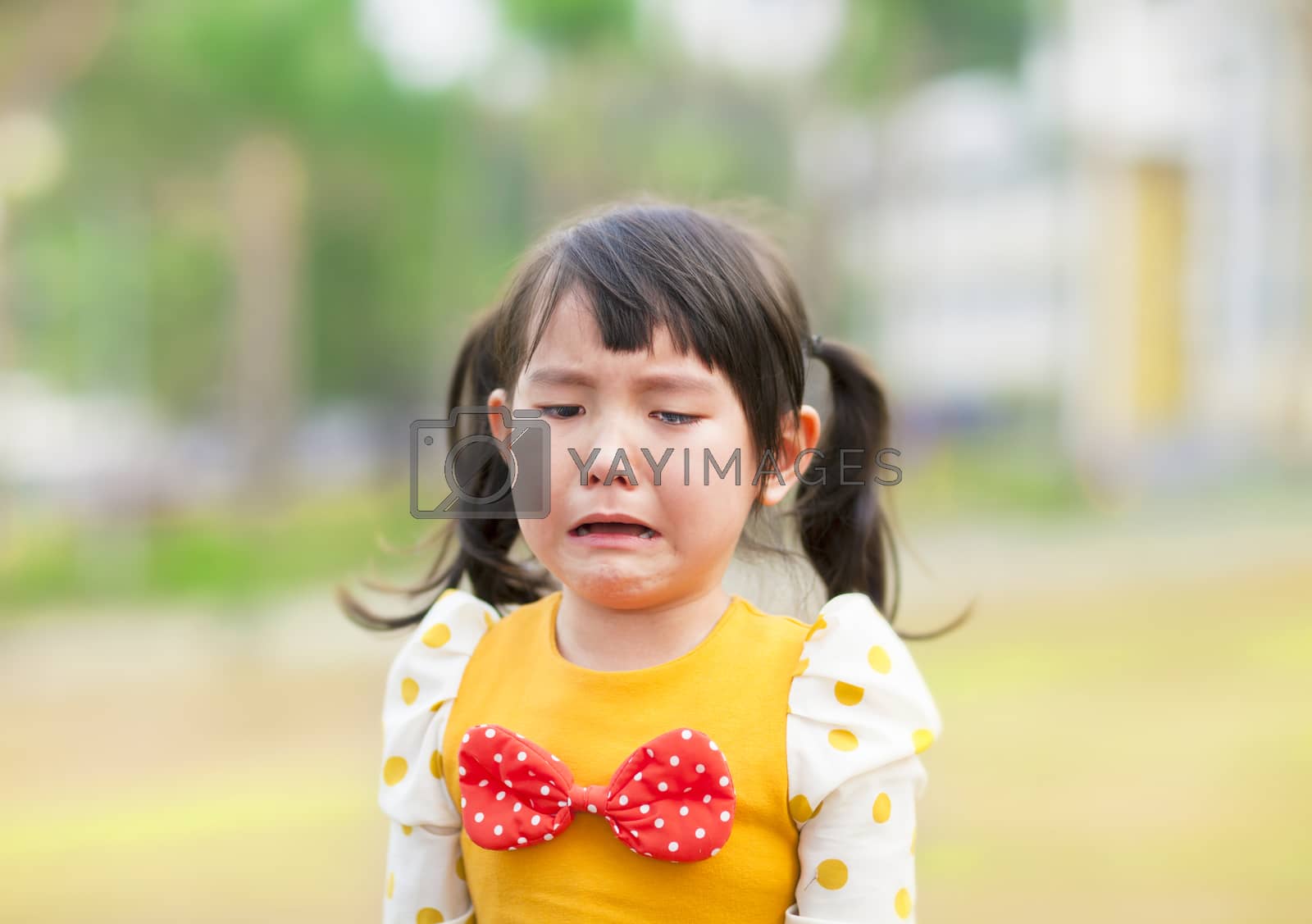 Royalty free image of crying little girl in the park by tomwang