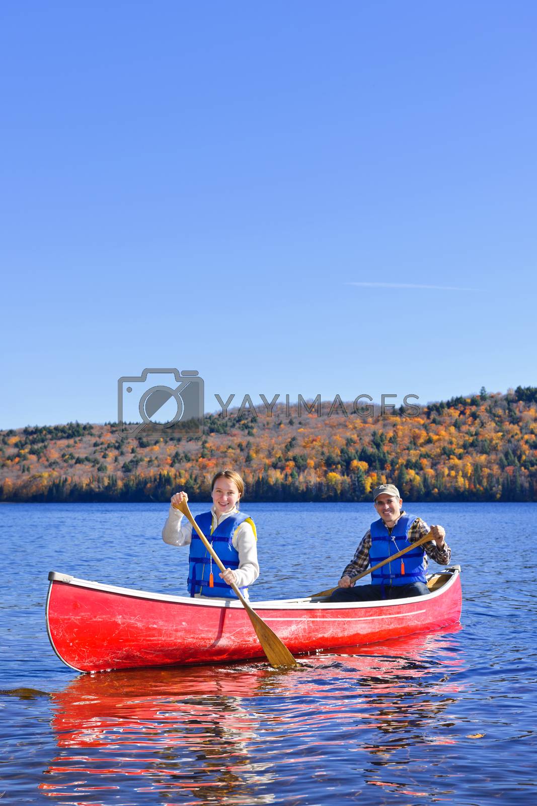 Royalty free image of Canoe trip on scenic lake in fall by elenathewise