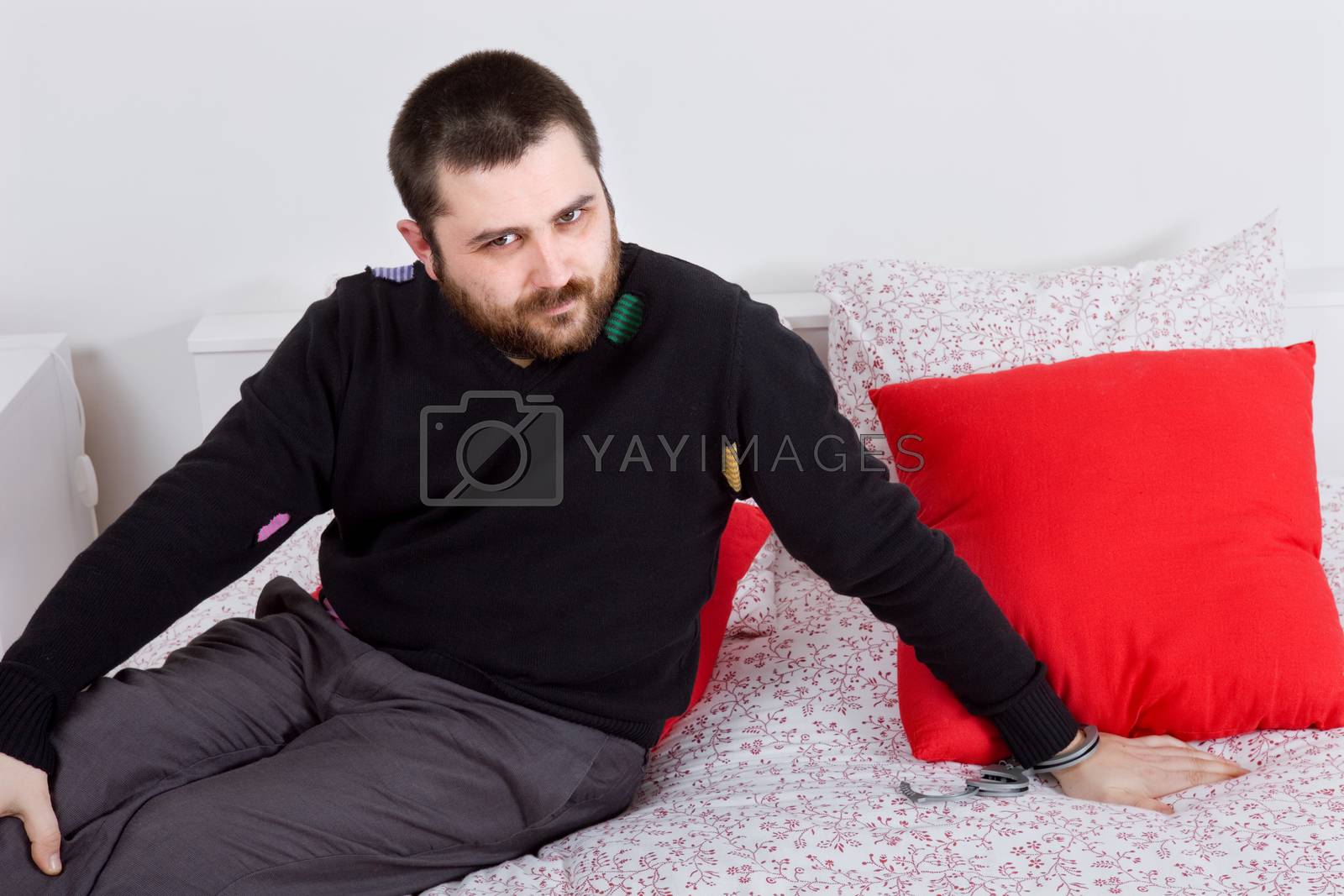 Royalty free image of silly man in bed by zittto