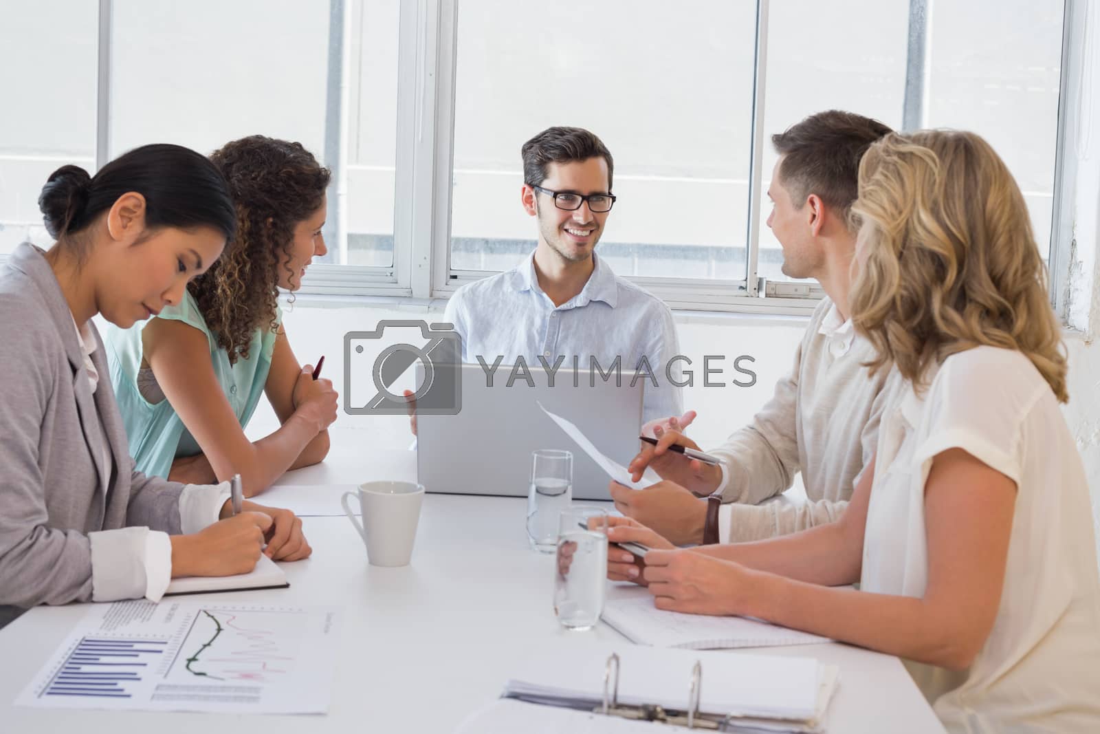 Royalty free image of Casual businessman talking to team during meeting by Wavebreakmedia
