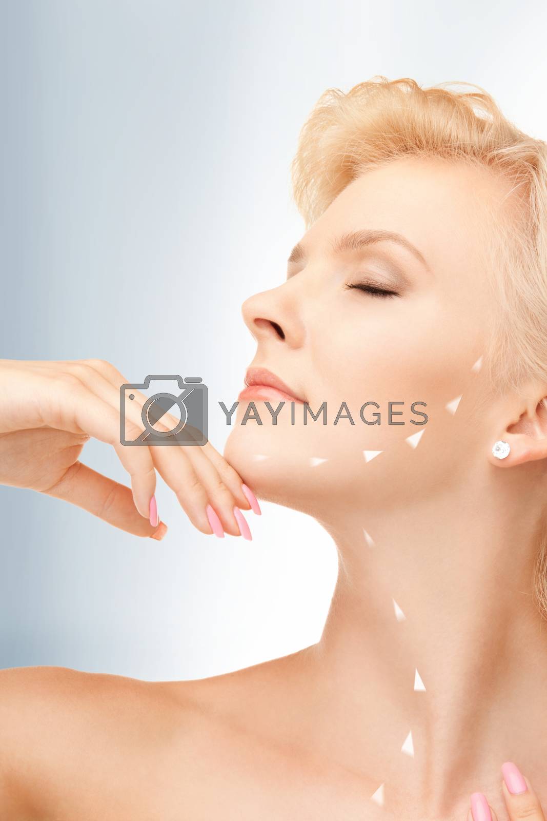 Royalty free image of face and hands of beautiful woman by dolgachov