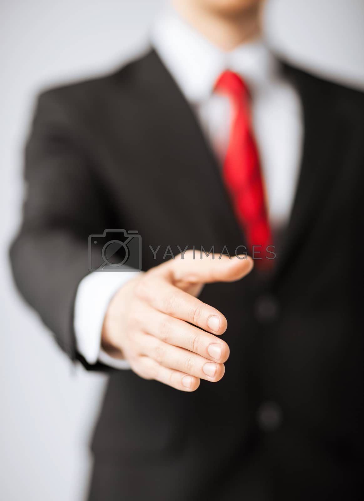 Royalty free image of businessman with open hand by dolgachov