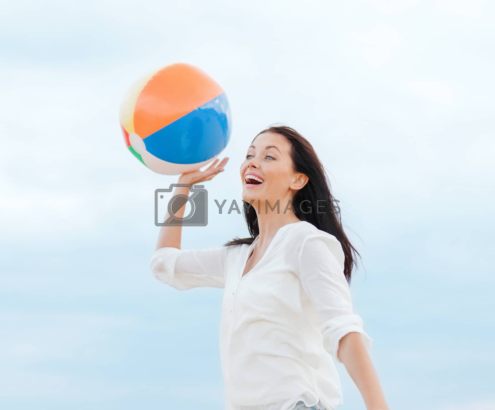 Royalty free image of girl with ball on the beach by dolgachov
