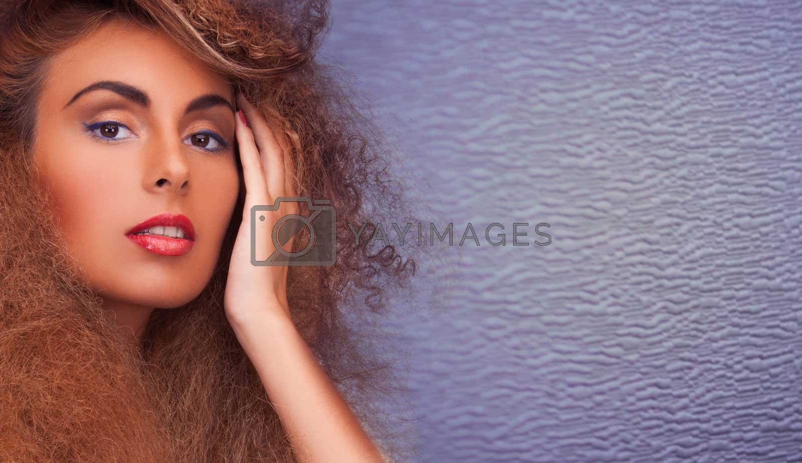 Royalty free image of woman with long curly hair by dolgachov