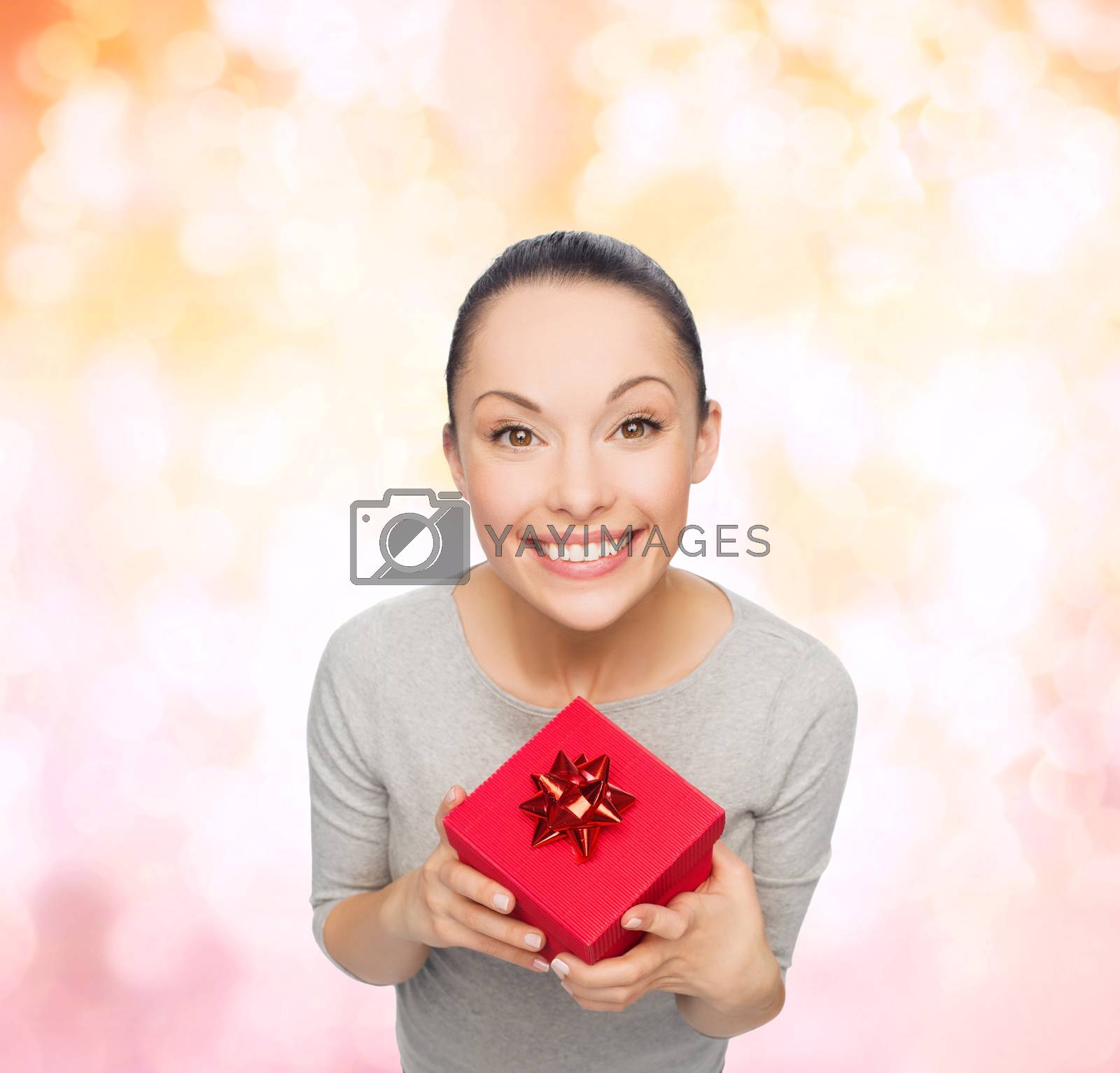 Royalty free image of smiling asian woman with red gift box by dolgachov