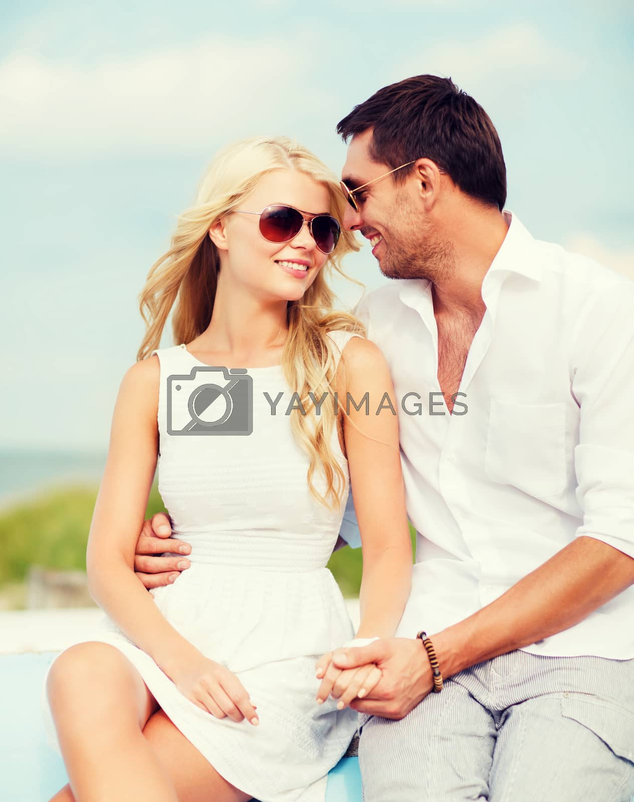 Royalty free image of couple in shades at seaside by dolgachov