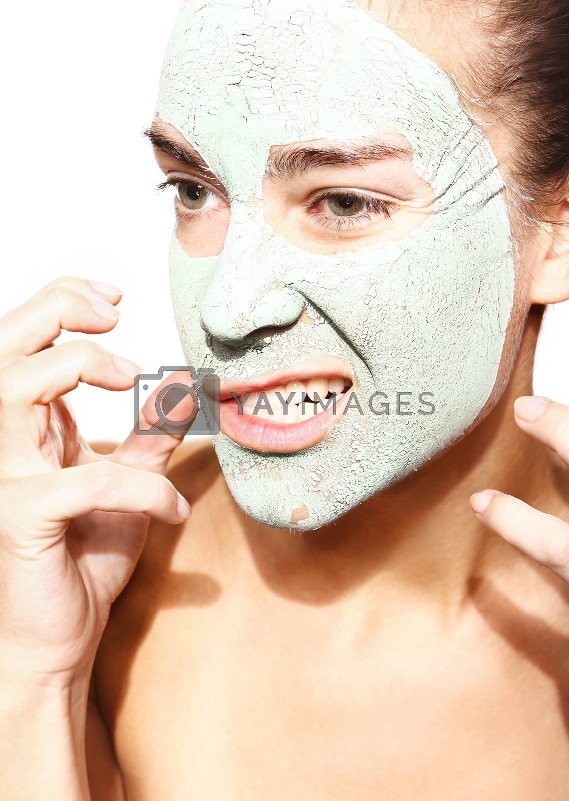 Royalty free image of impatient woman in the mask with green clay by robert_przybysz