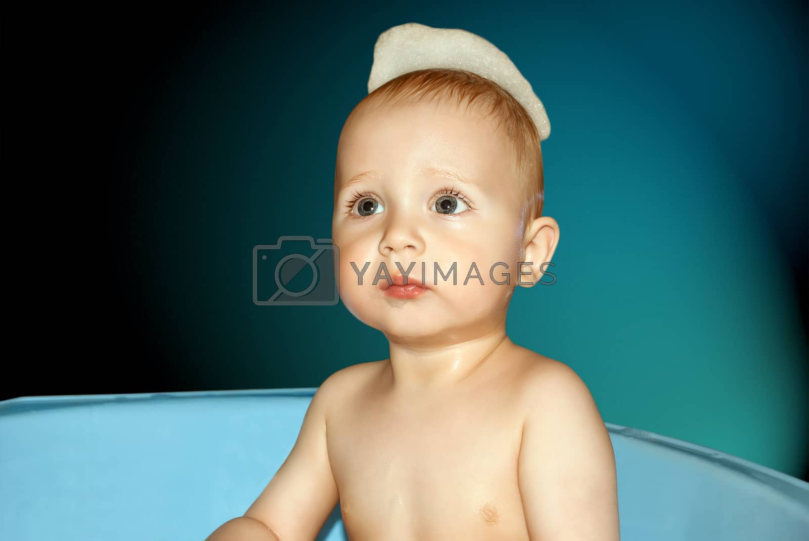Royalty free image of Baby face closeup bathing in the tub. by negativ