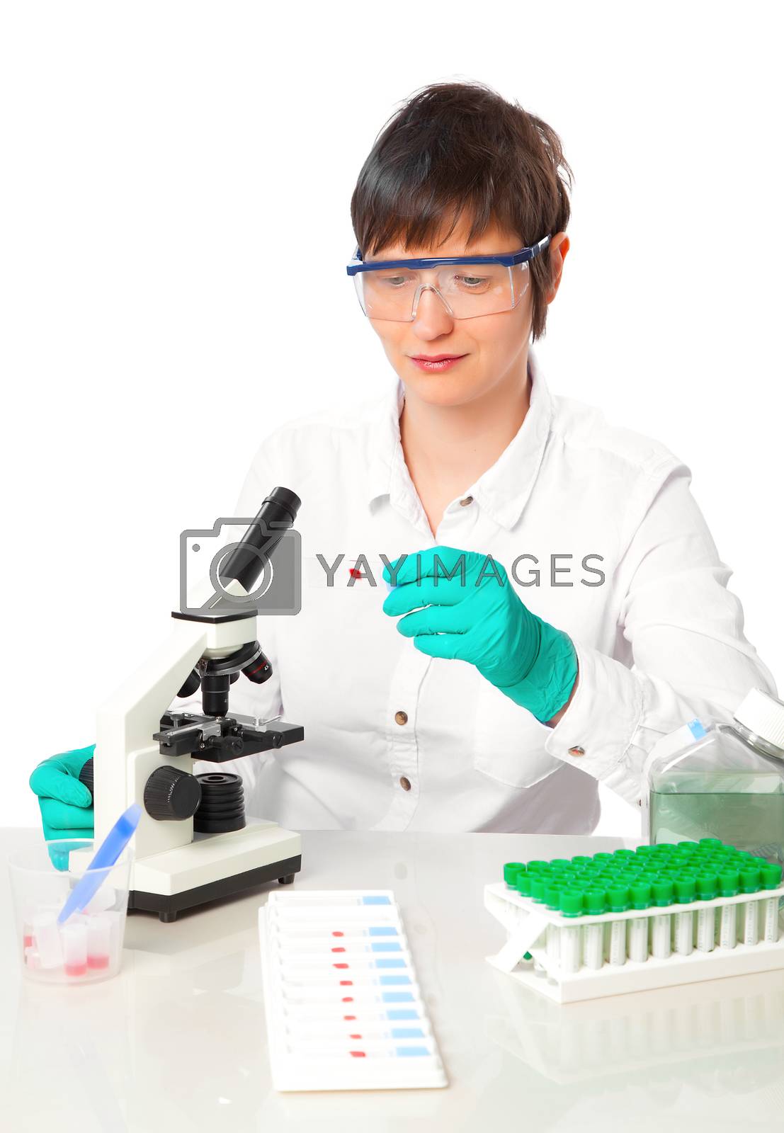 Royalty free image of Girl working at the laboratory with microscope by motorolka