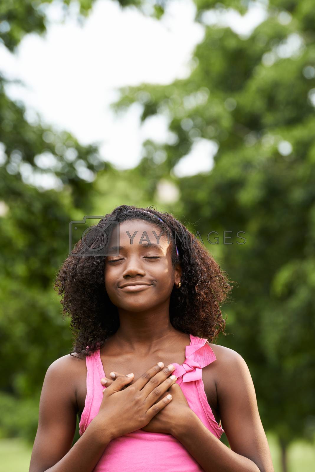 Royalty free image of Portrait of black girl in love daydreaming and smiling by diego_cervo