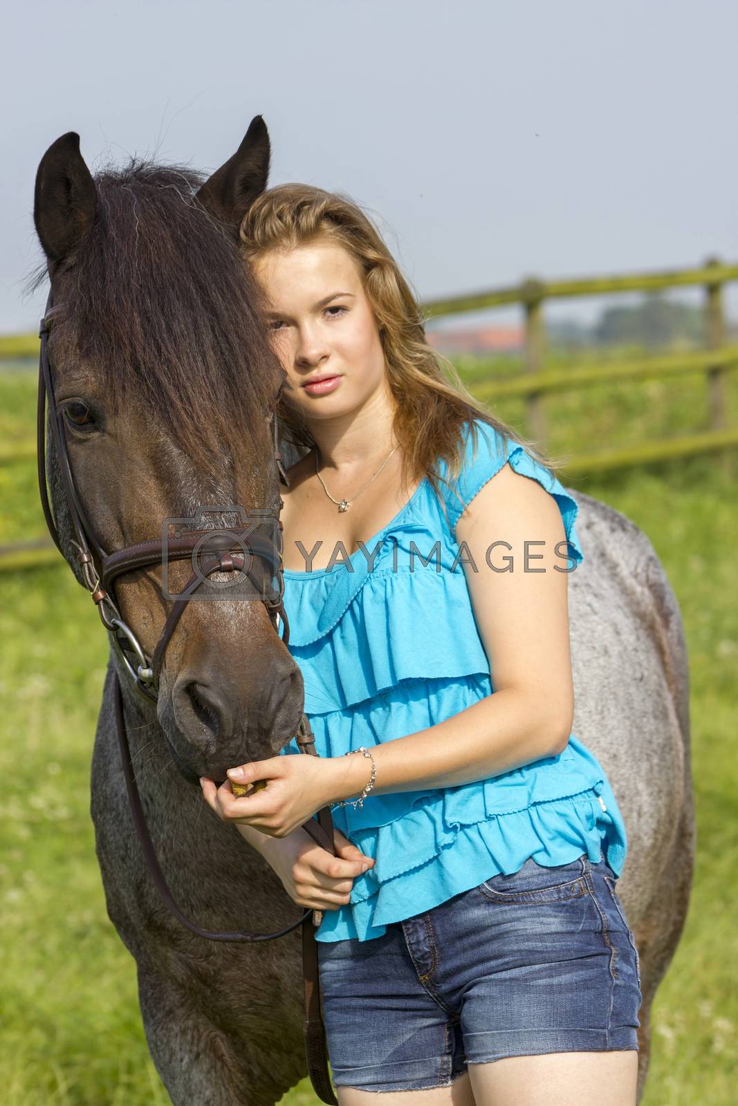 Royalty free image of young girl and her horse by miradrozdowski