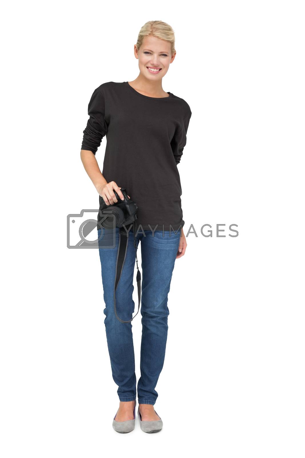 Royalty free image of Full length portrait of a female photographer by Wavebreakmedia