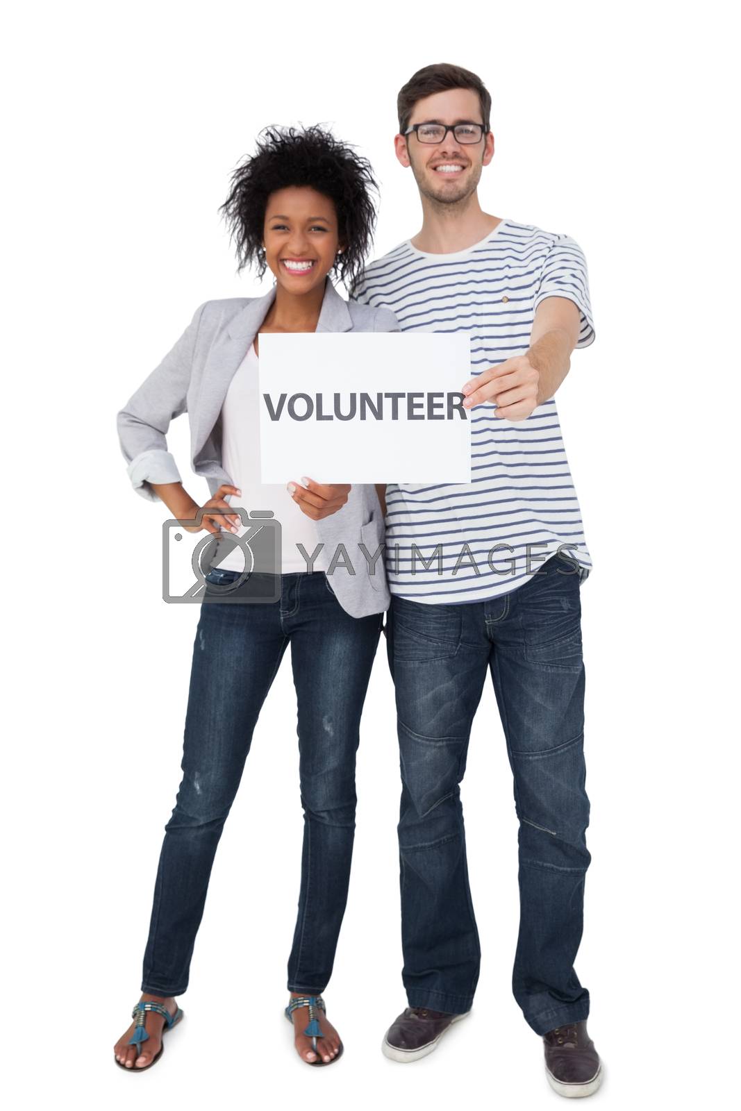 Royalty free image of Portrait of a happy couple holding a volunteer note by Wavebreakmedia