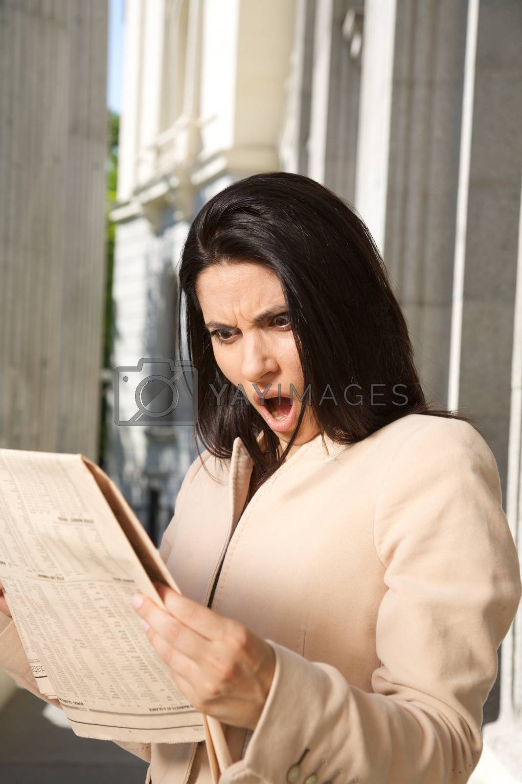 Royalty free image of surprised businesswoman reading journal by quintanilla