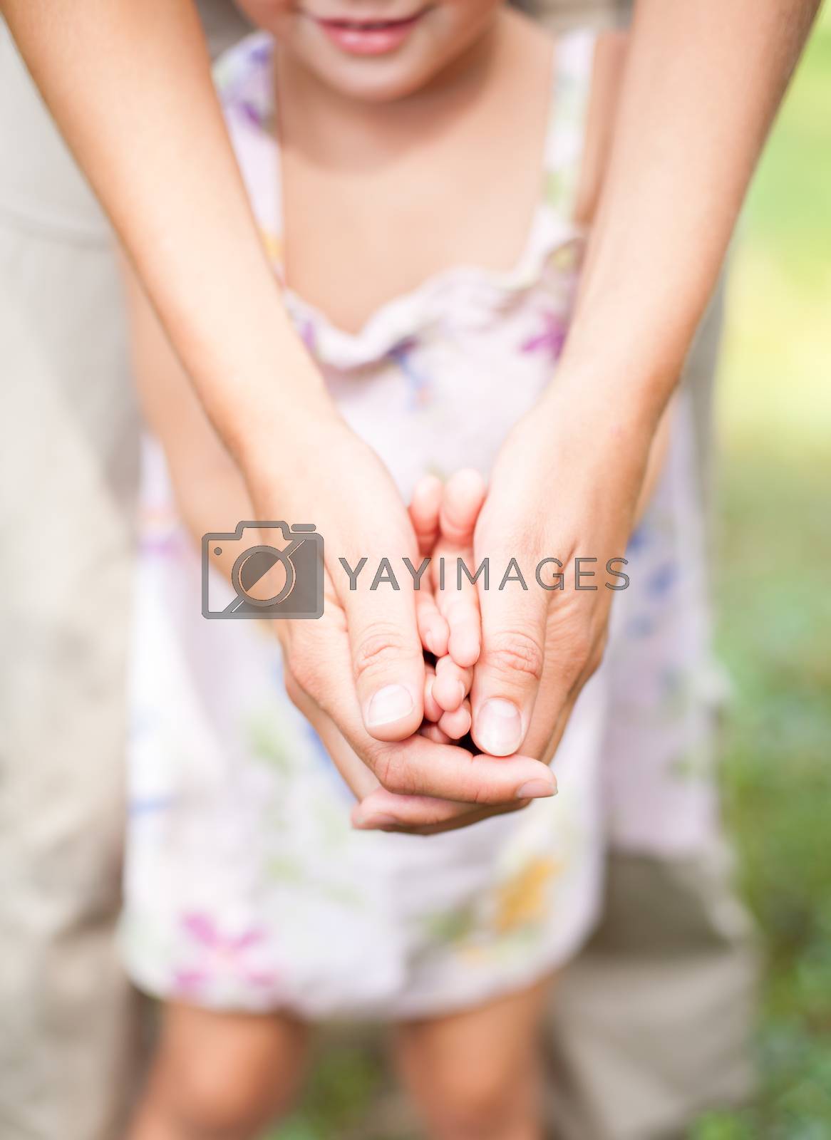 Royalty free image of Mother with daughter outdoors by naumoid