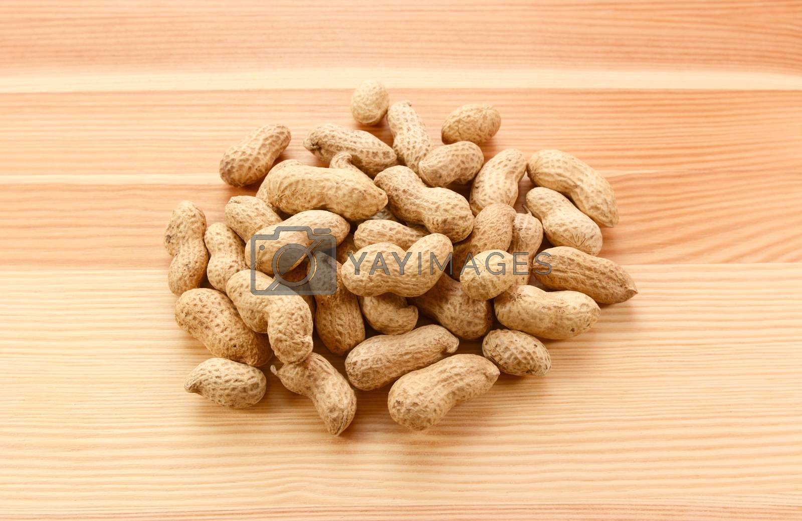 Royalty free image of Heap of monkey nuts, peanuts or groundnuts in shells by sarahdoow