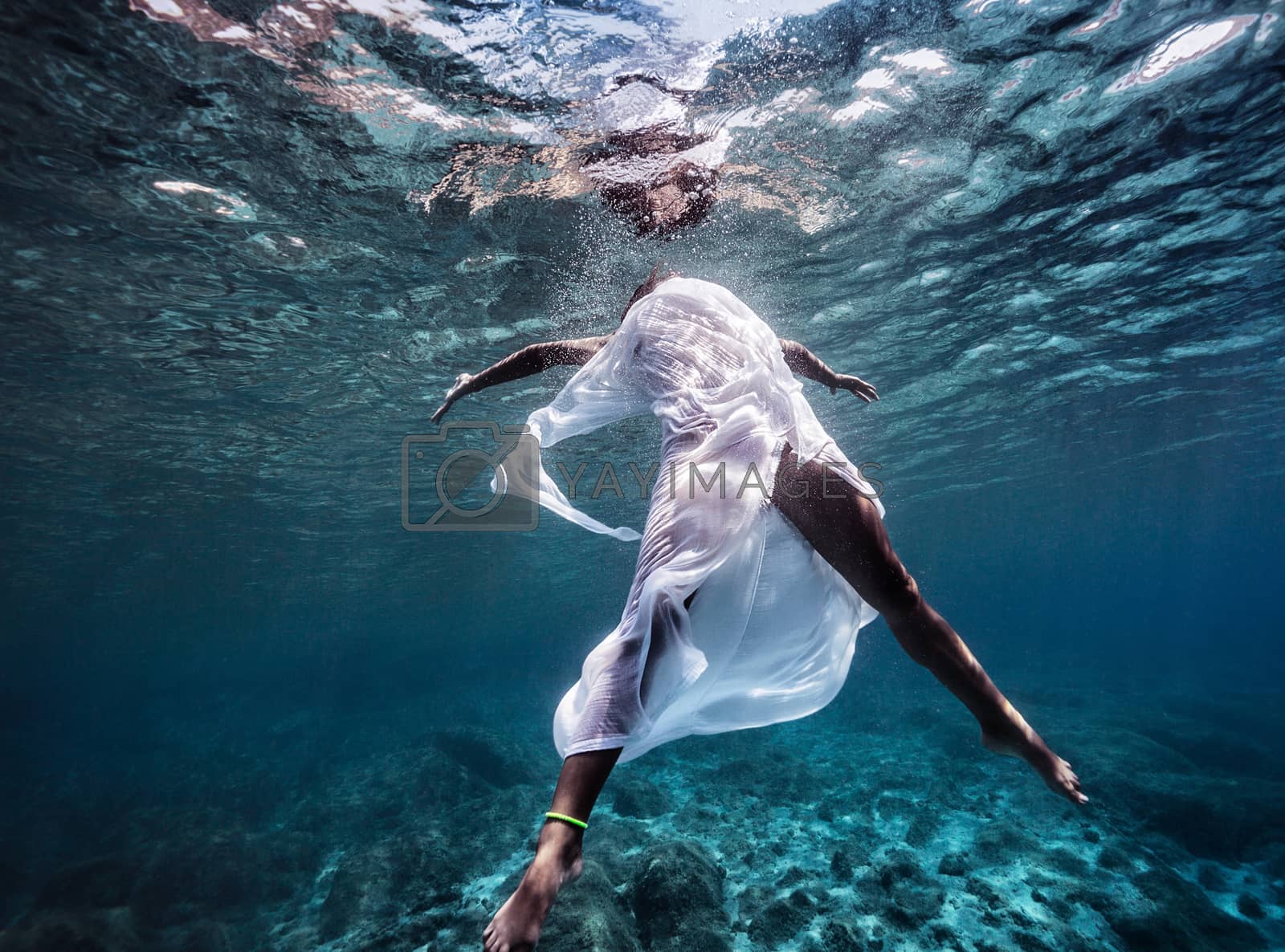 Royalty free image of Fashionable model dancing underwater by Anna_Omelchenko