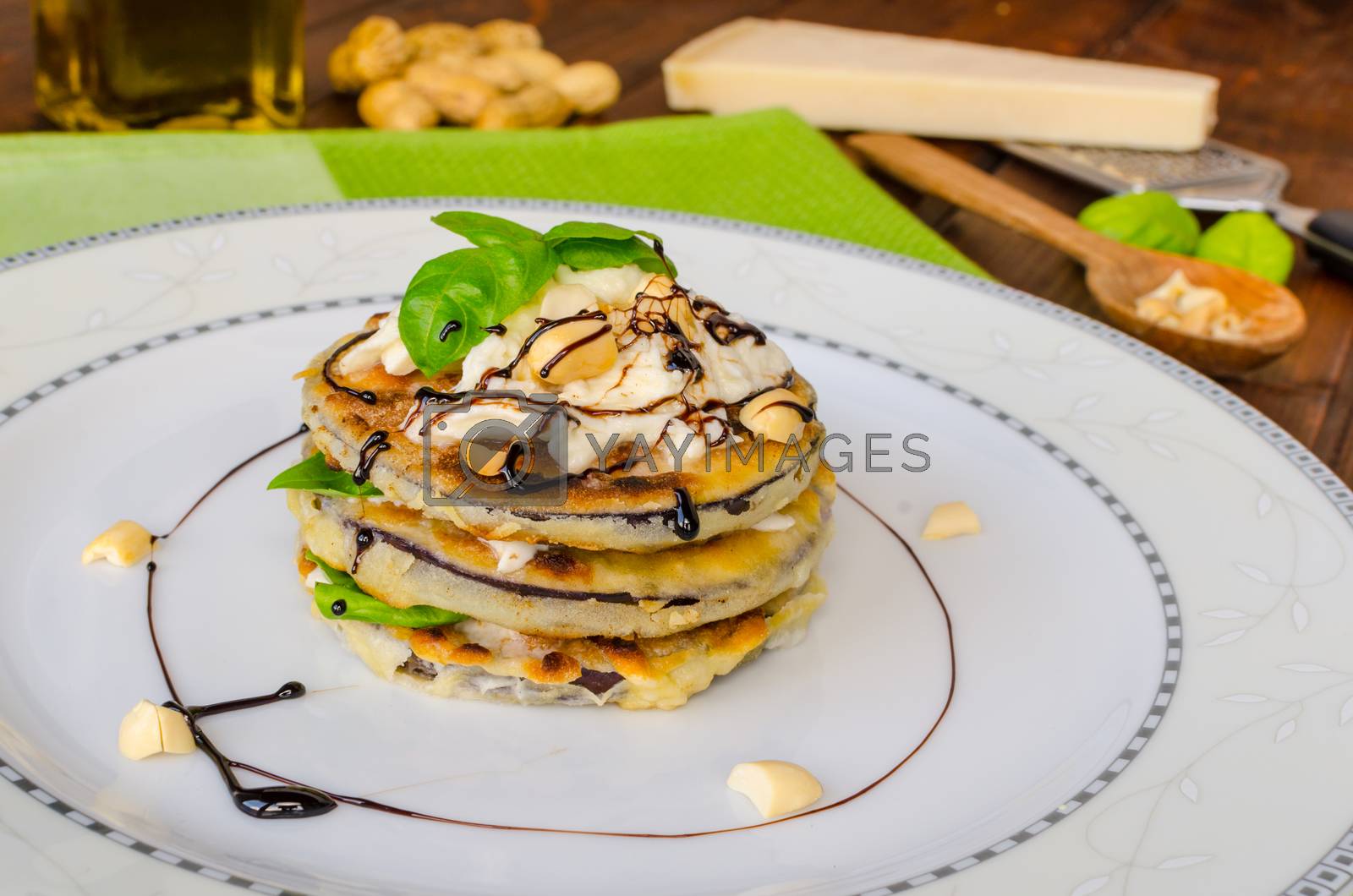 Royalty free image of Grilled eggplant with feta cheese,parmesan basil, nuts by Peteer