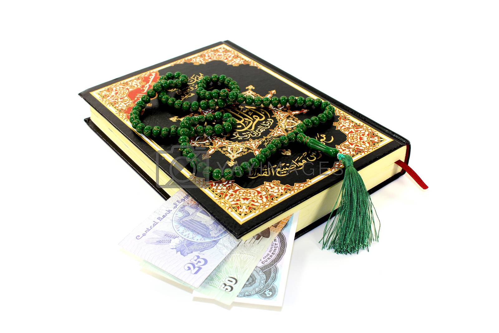 Royalty free image of whipped Quran with Egyptian piastre by discovery