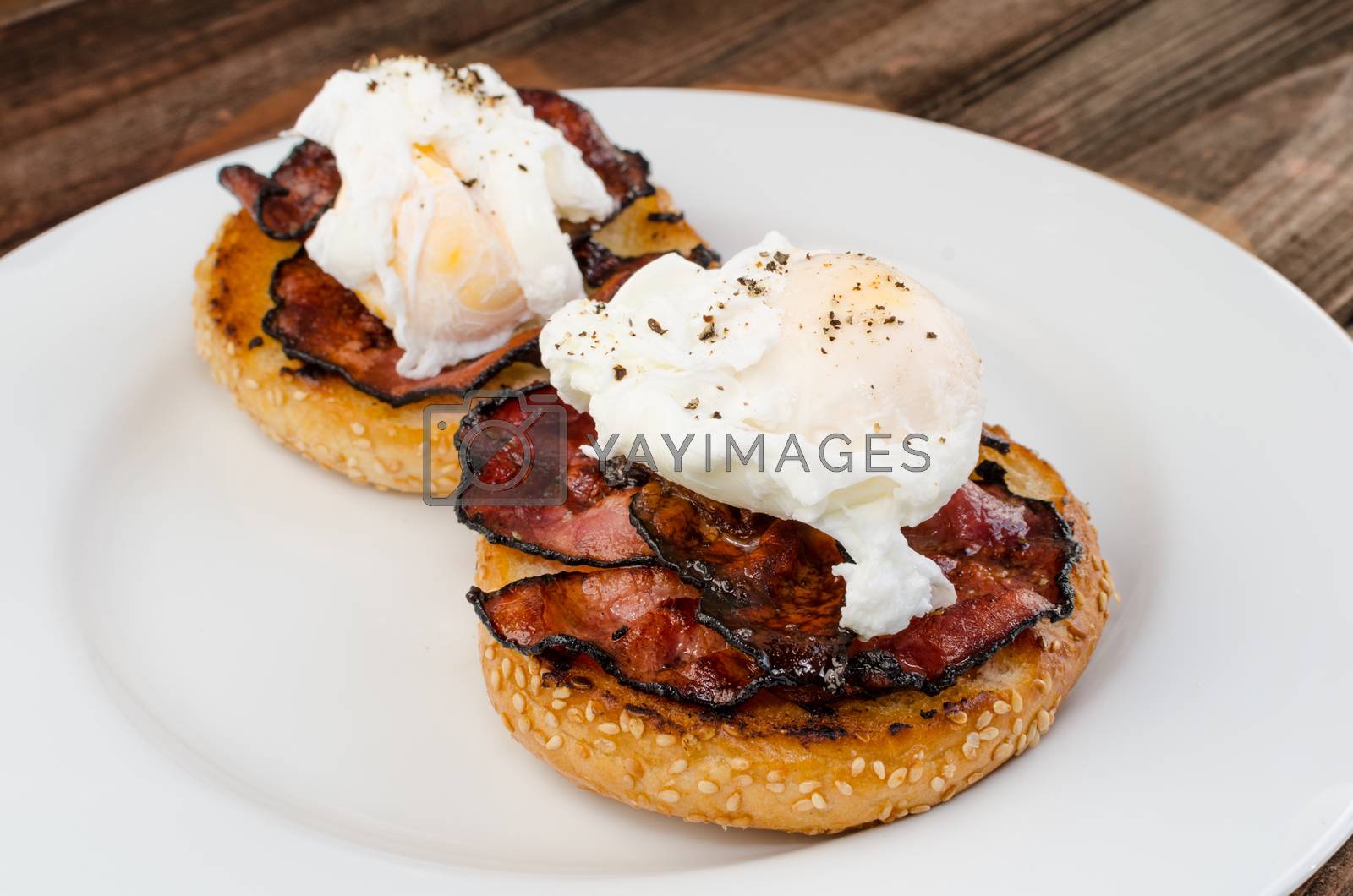 Royalty free image of Benedict eggs with crispy bacon and hollandaise sauce on toasted Maffin by Peteer