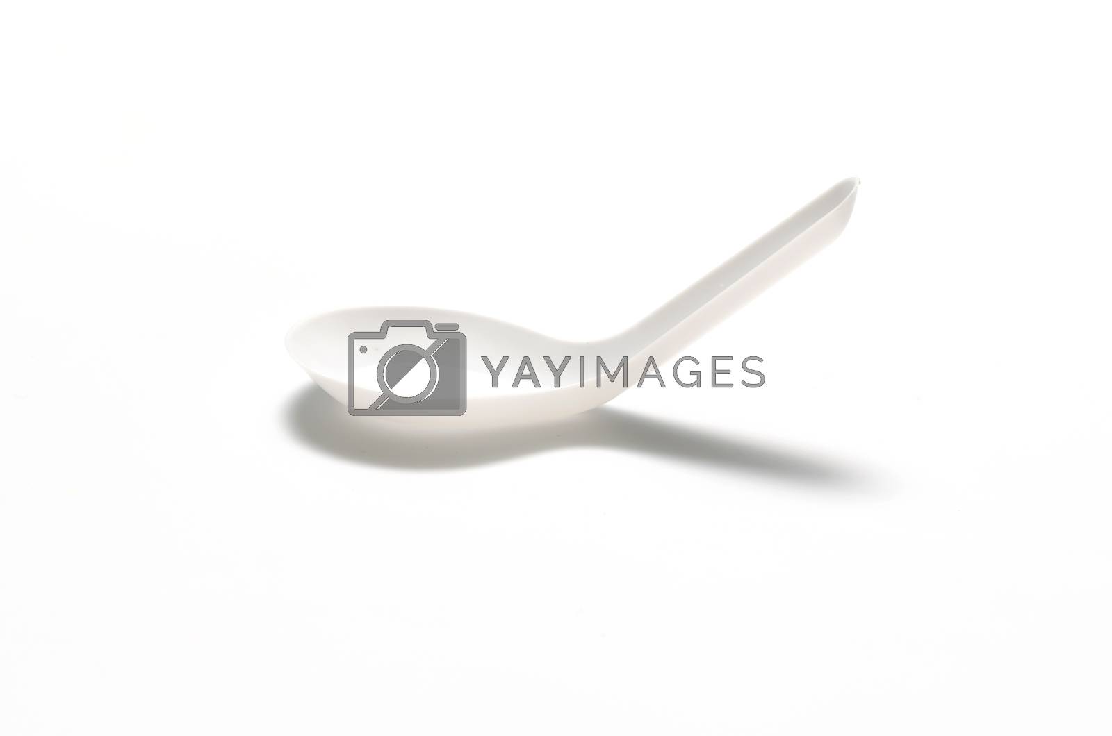 Royalty free image of white plastic spoon by ammza12