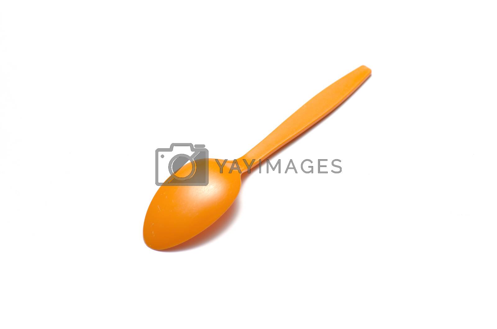 Royalty free image of orange plastic spoon by ammza12