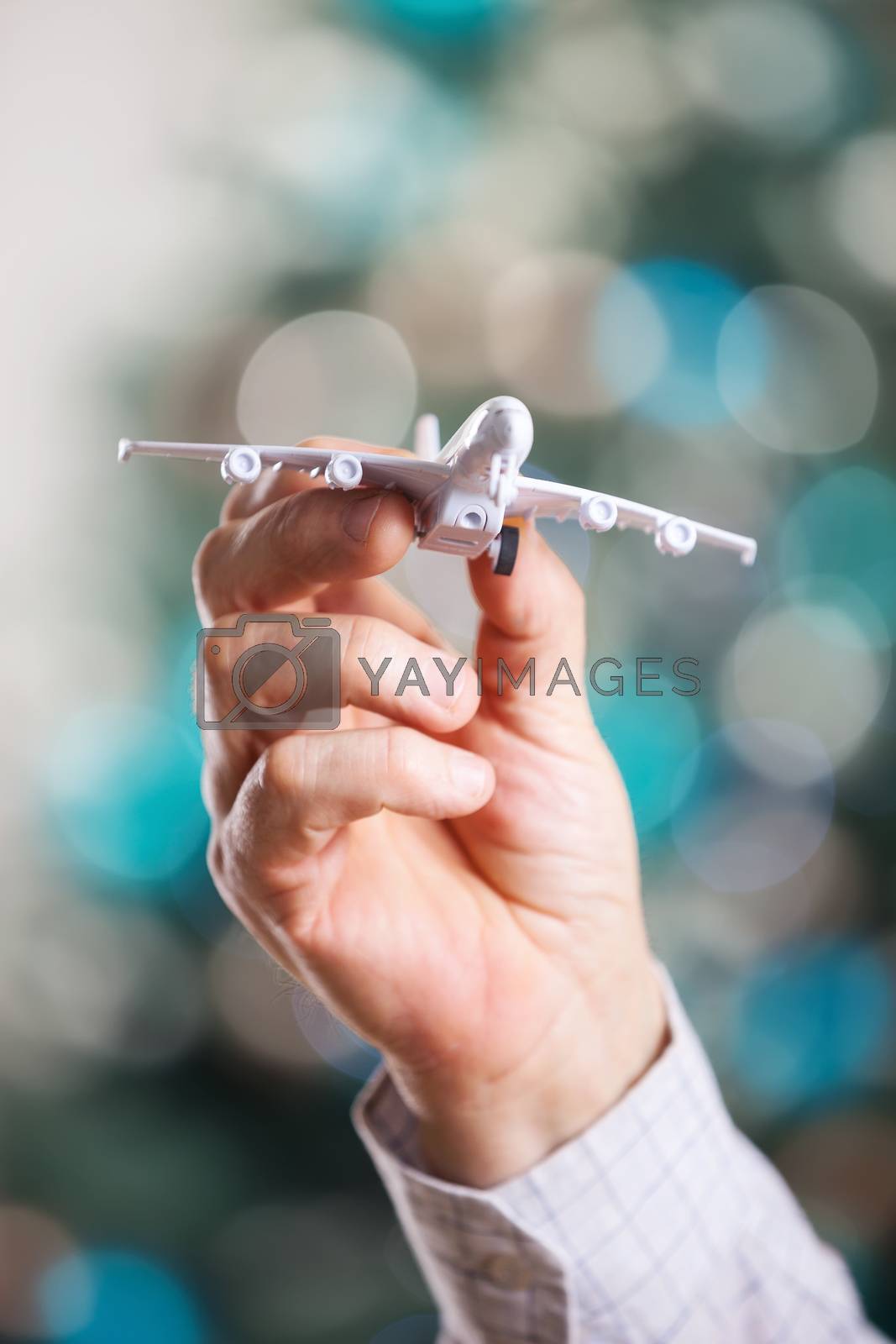Royalty free image of Closeup of man hand holding model of airplane by photobac