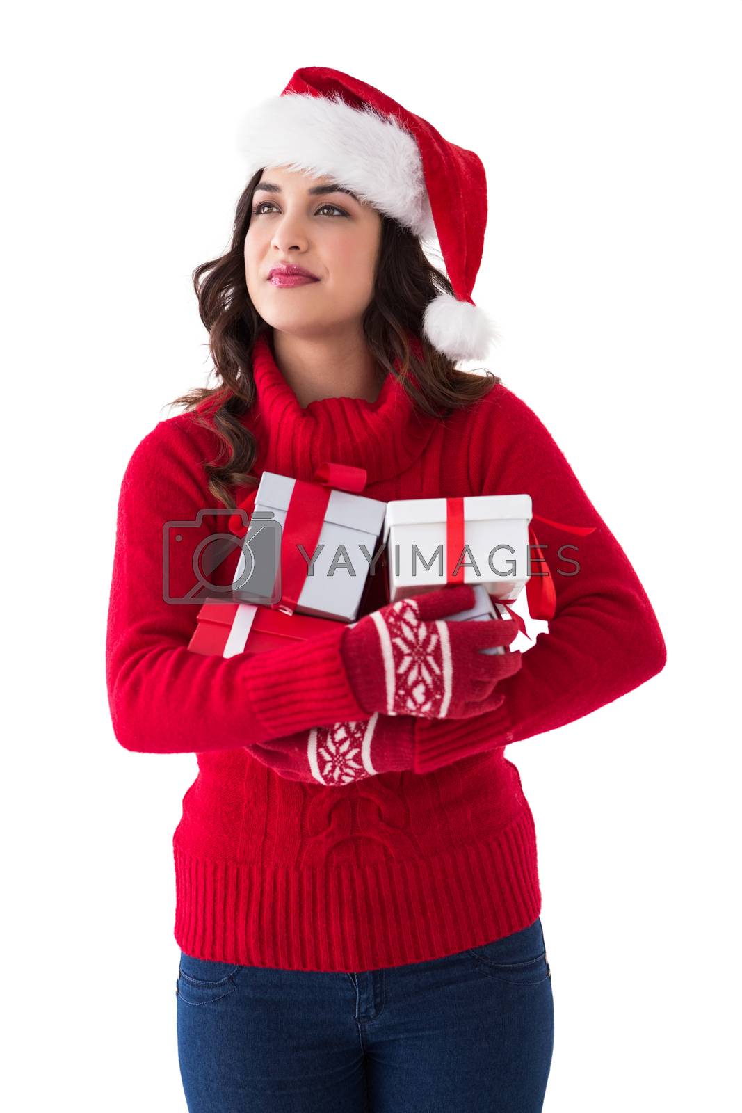 Royalty free image of Thoughtful brunette holding many gifts  by Wavebreakmedia